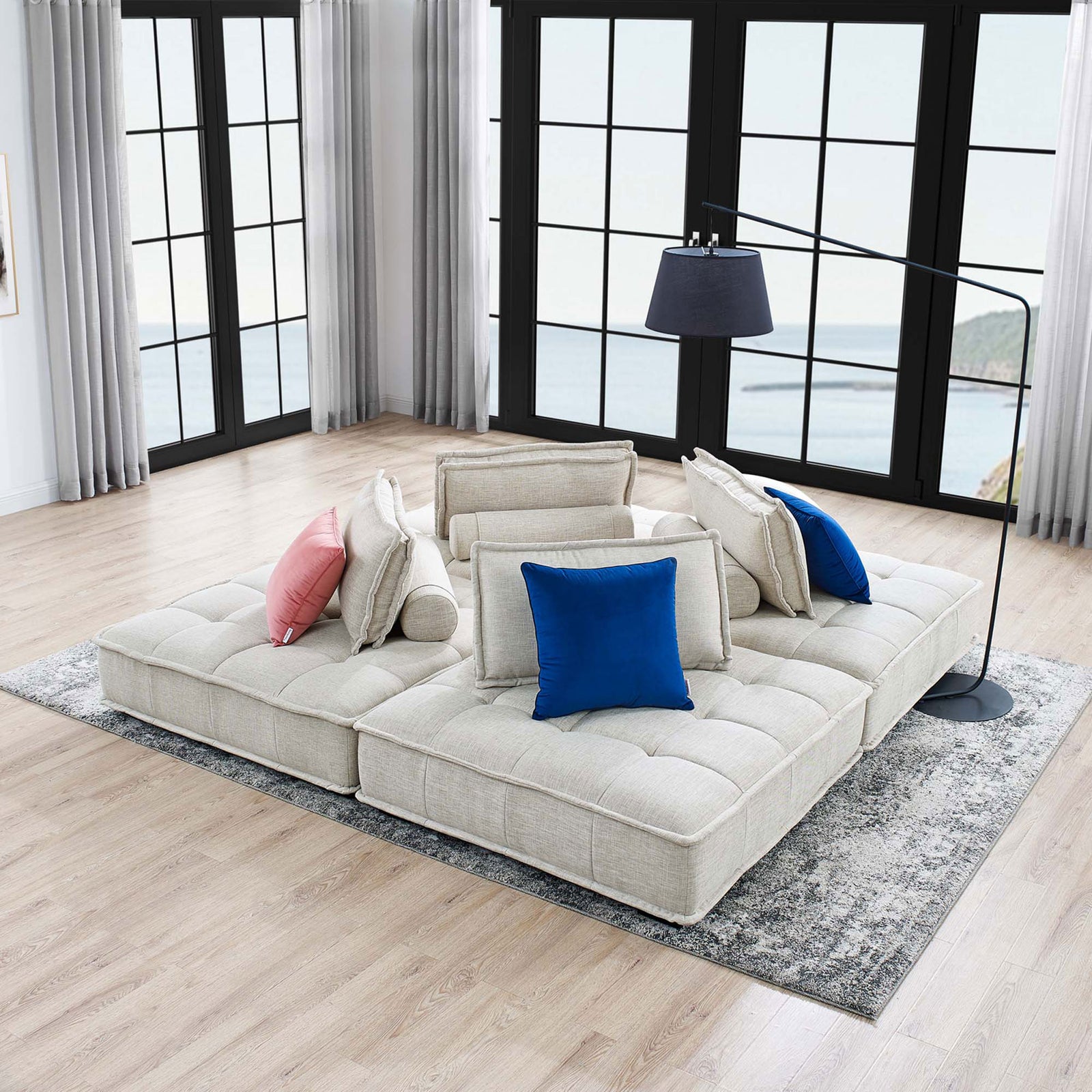 Full Saunter sectional anchors a spacious living area with modern decor, floor lamp, and textured area rug || EEI-5208-BEI || front_angle_room