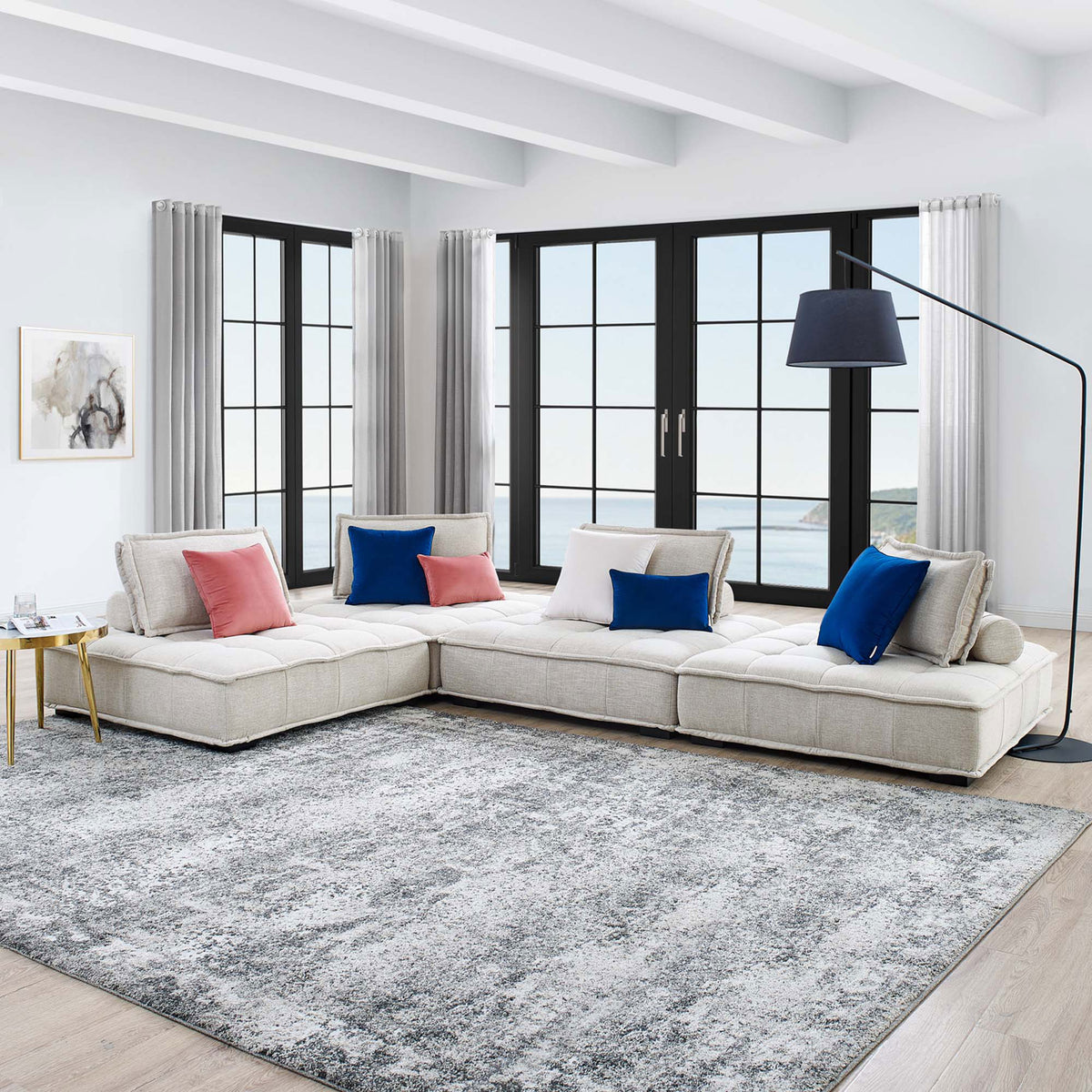 L-shaped Saunter sectional creates an inviting lounge space with airy windows, side table, and floor lamp || EEI-5208-BEI || front_angle_room