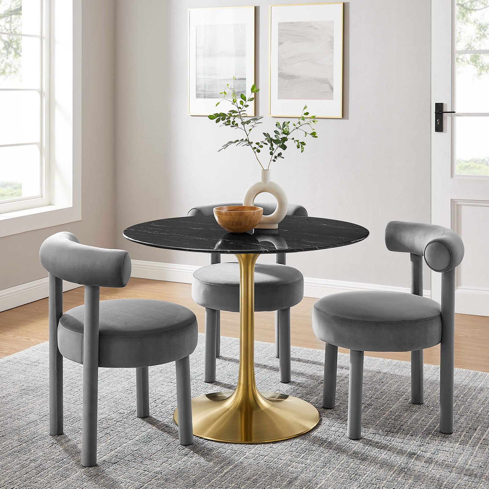 40 inch black faux marble pedestal dining table arranged with three gray chairs in a cozy contemporary room || EEI-5238-GLD-BLK || front_angle_room
