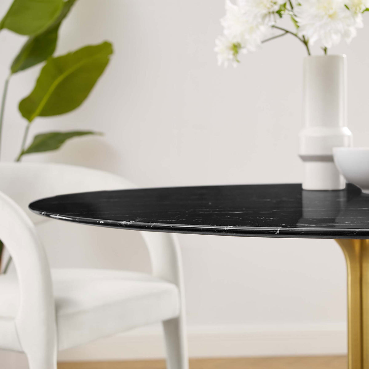 Black faux marble tabletop styled with white chairs and flowers accentuating the slim beveled edge || EEI-5240-GLD-BLK || detail_room