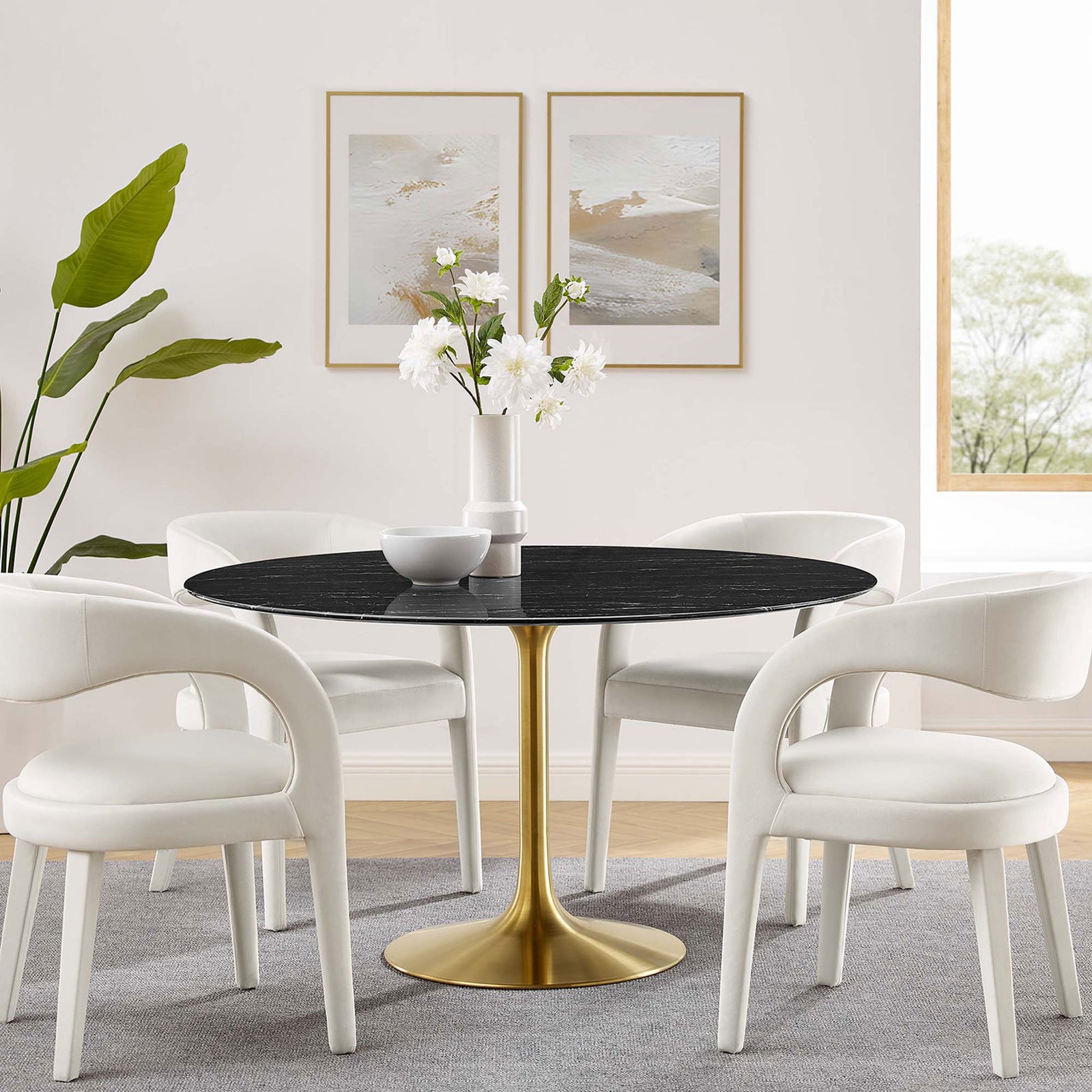 54 inch black faux marble pedestal dining table paired with four white chairs in a bright contemporary dining room || EEI-5240-GLD-BLK || front_angle_room