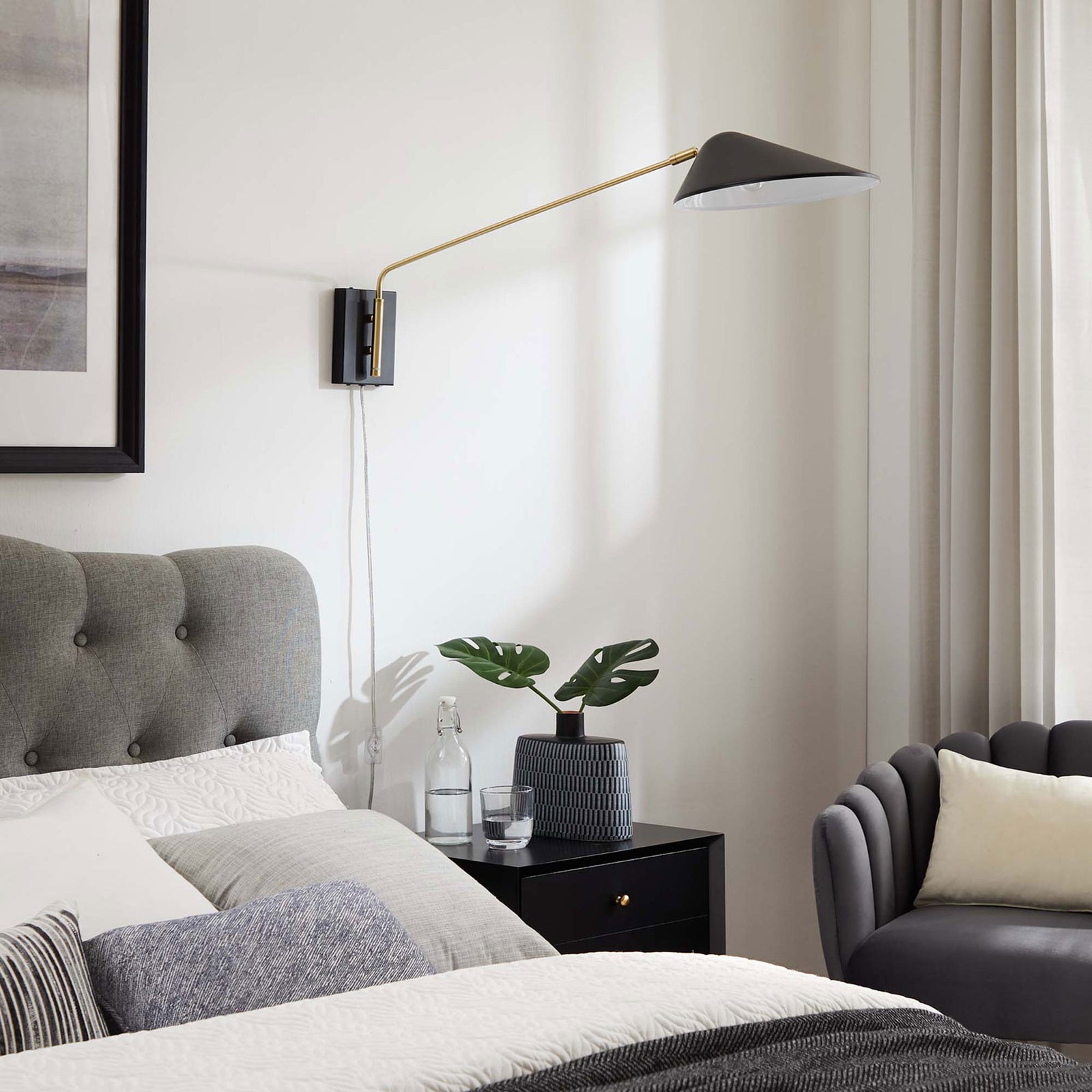 Extended swing arm sconce adds sculptural interest above a modern nightstand. || EEI-5295-BLK || front_angle_room
