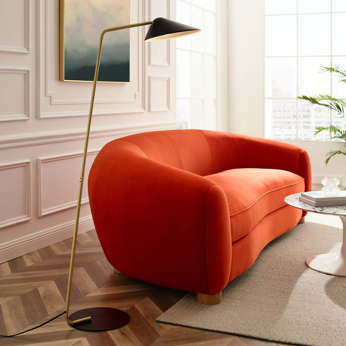 Contemporary floor lamp with slender brass pole and black shade illuminates a stylish lounge seating area || EEI-5298-BLK || side_room