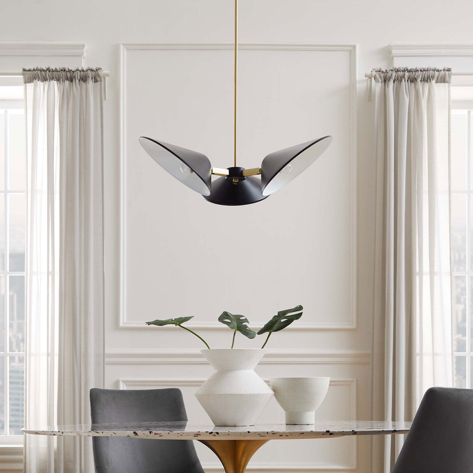 Crisp modern pendant elevates a dining room setting above the table || EEI-5299-BLK || front_room