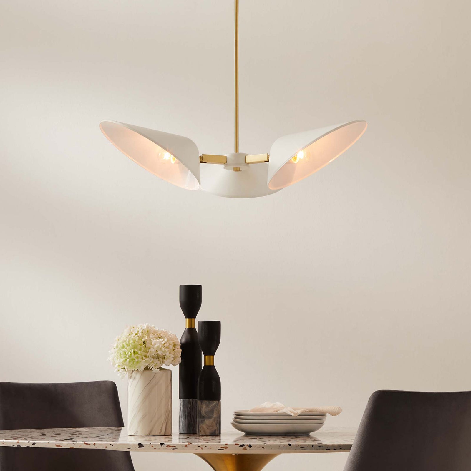 Glowing three-light pendant warms the room with soft light and elegant brass details || EEI-5299-WHI || front_on_room