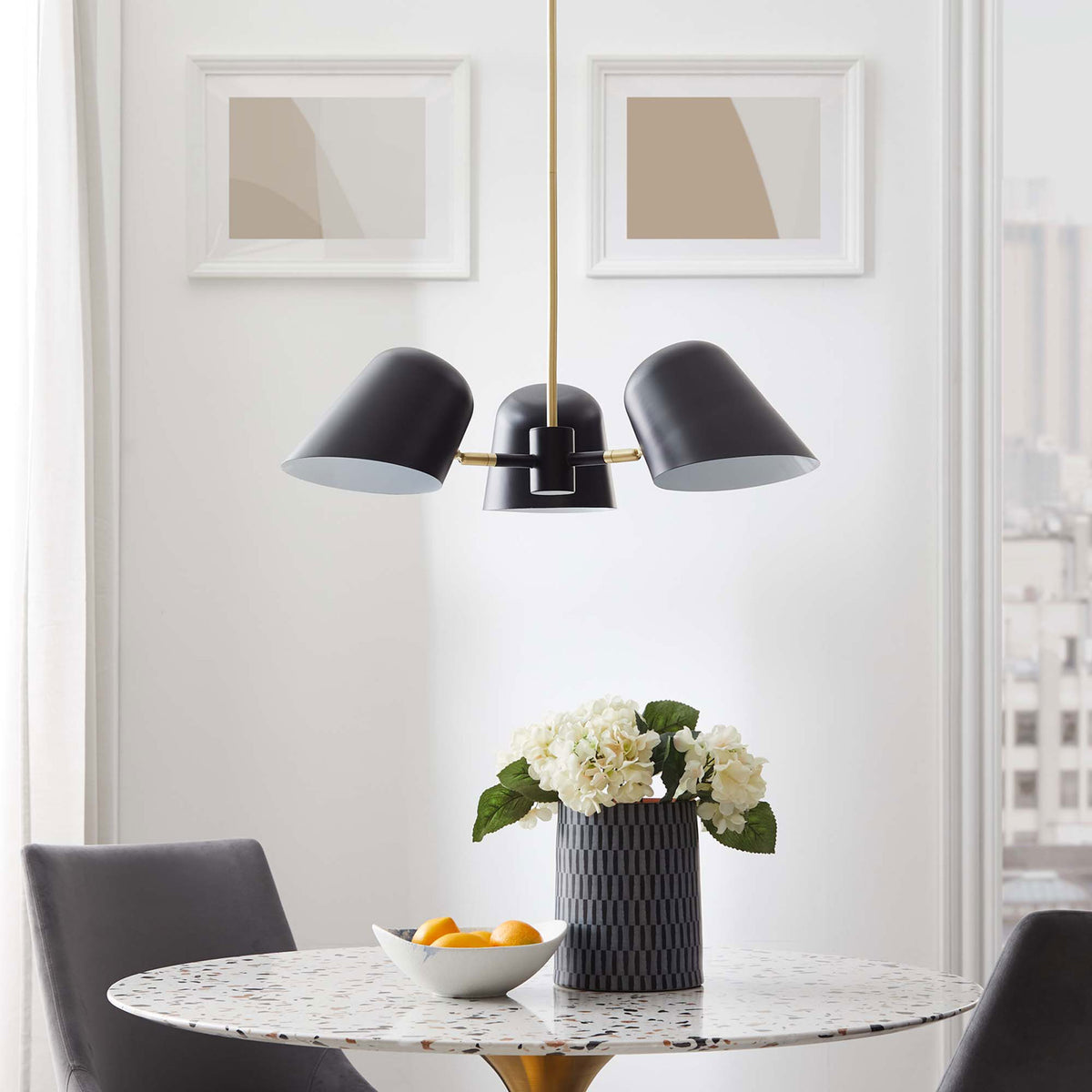 Modern three-light pendant lends refined contrast above the table with black shades and brass accents || EEI-5301-BLK || front_room