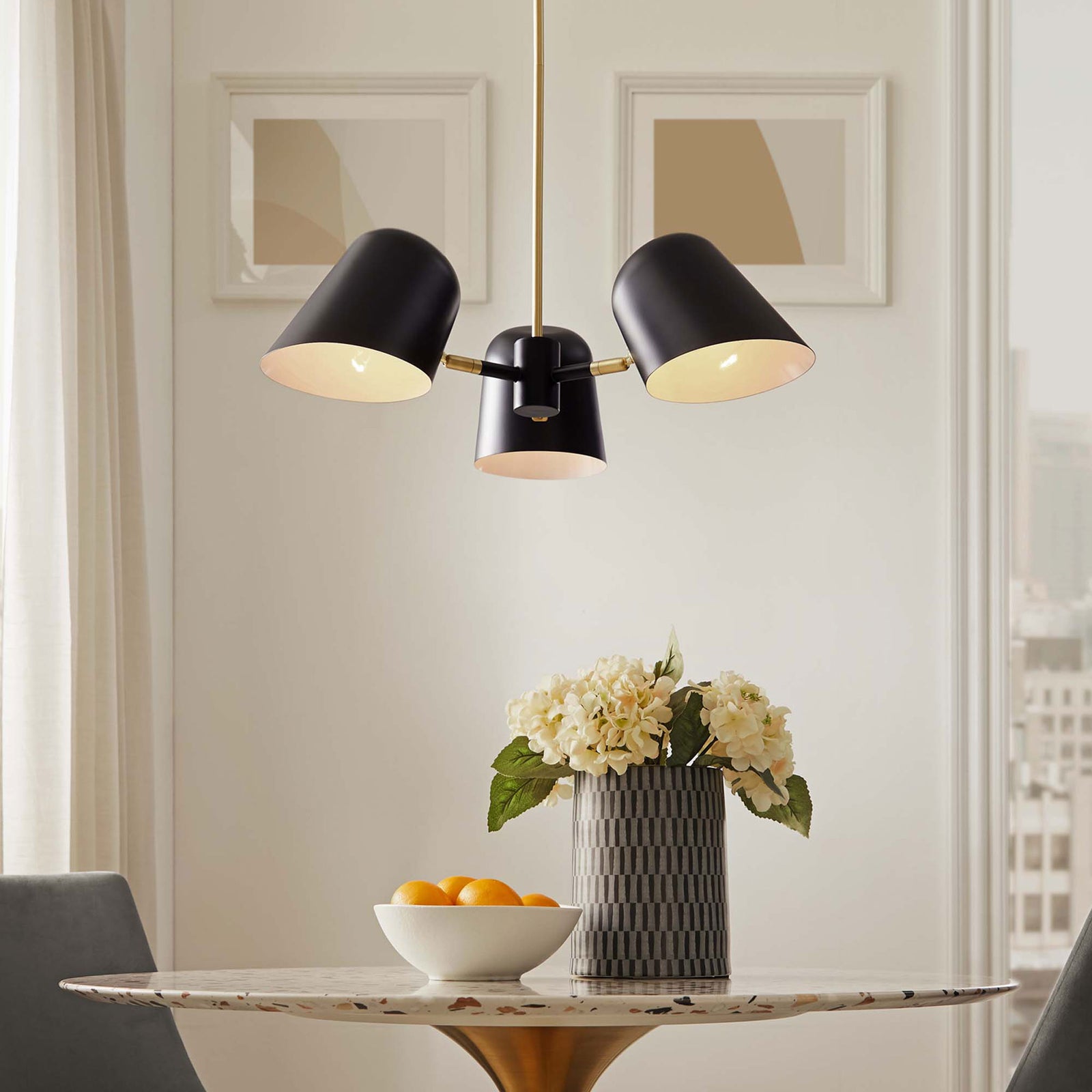 Warm ambient glow from three black metal shades sets a cozy mood with elegant satin brass details || EEI-5301-BLK || front_on_room