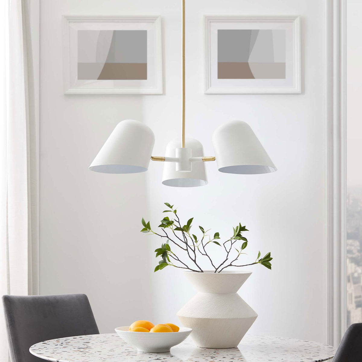 Sculptural pendant elevates dining decor with crisp white shades and warm brass details || EEI-5301-WHI || front_room