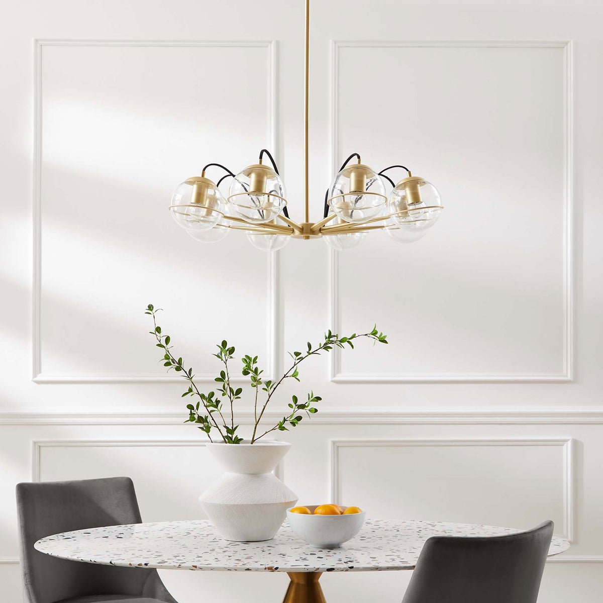 Elegant eight-globe chandelier brings warm brass sophistication to a dining space || EEI-5307-CLR-GLD || front_room