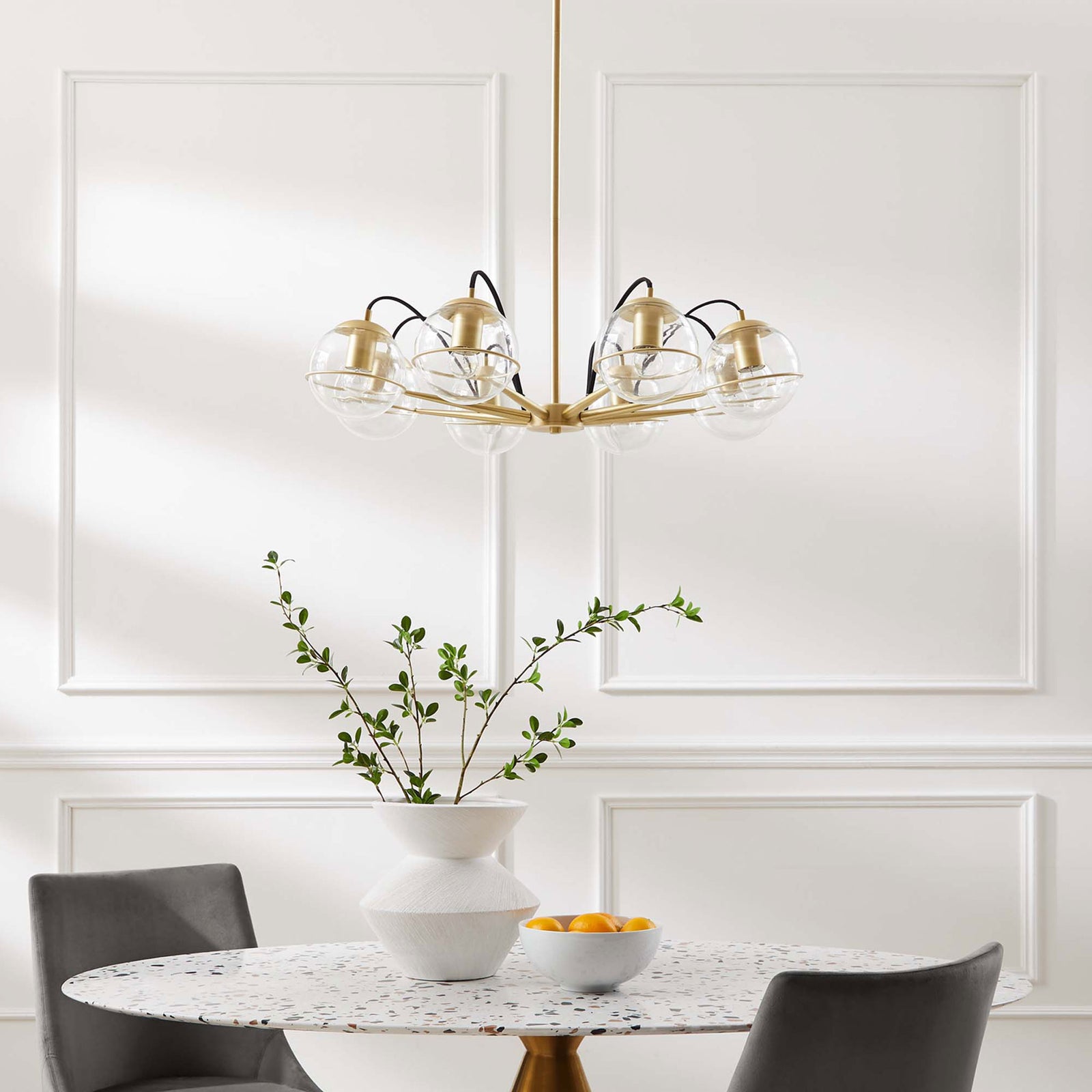 Elegant eight-globe chandelier brings warm brass sophistication to a dining space || EEI-5307-CLR-GLD || front_room