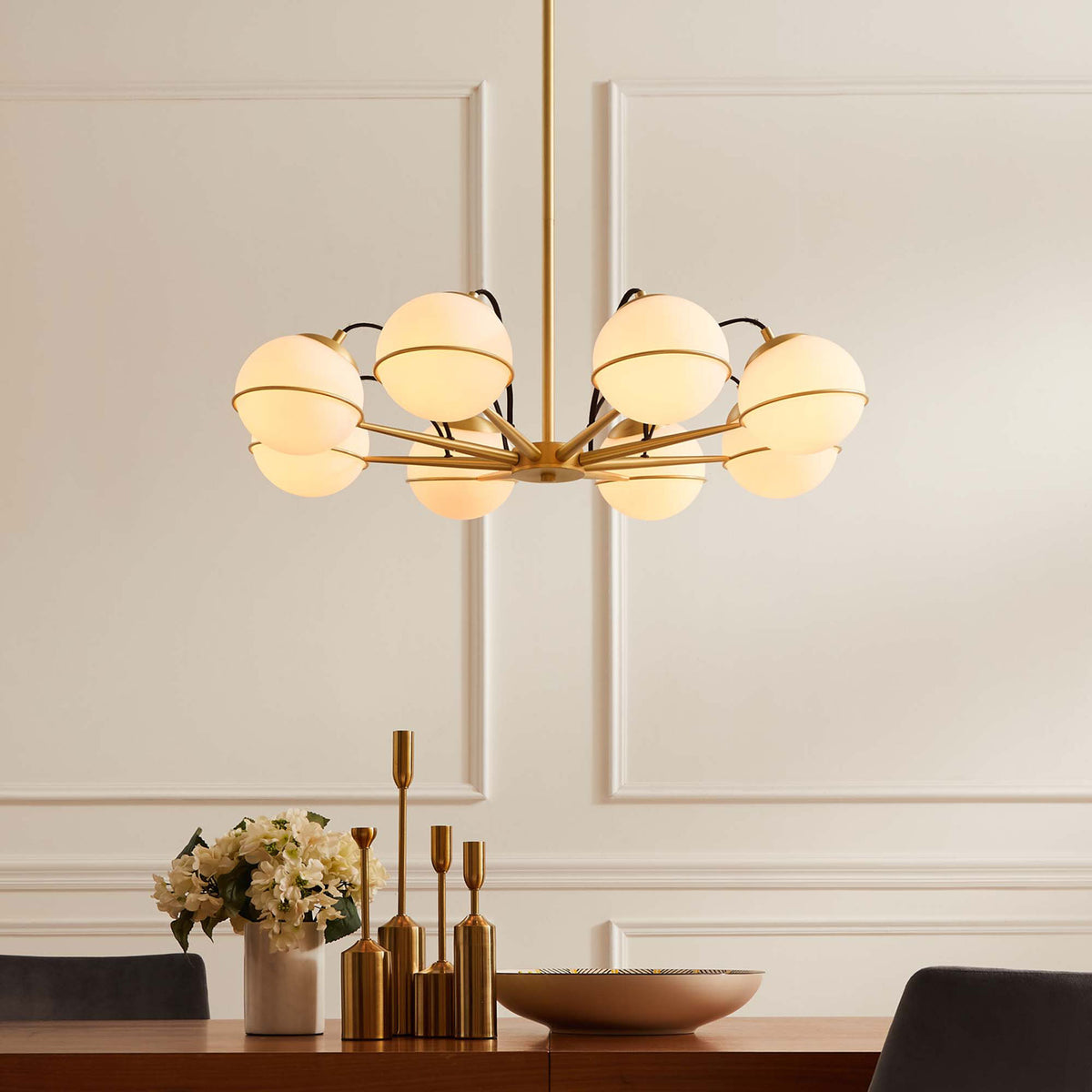 Soft, warm illumination highlights the chandelier's opal globes and luxe satin brass finish || EEI-5307-OPA-GLD || front_on_room