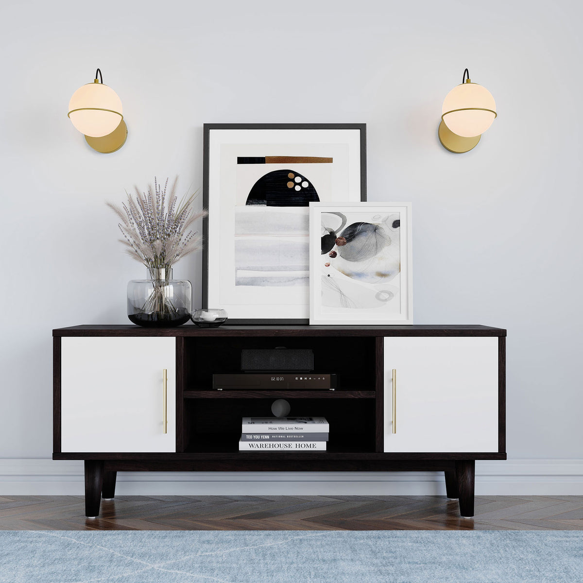 Pair of softly glowing opal globe sconces in satin brass adding warm light above a modern console || EEI-5308-OPA-GLD || front_on_room