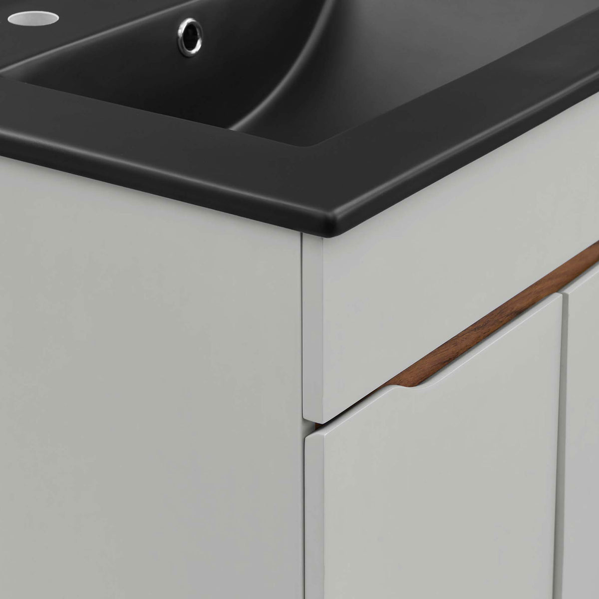 Rounded basin edge and wood-accented cutout pull provide refined texture and contrast || EEI-5357-GRY-BLK || detail_studio