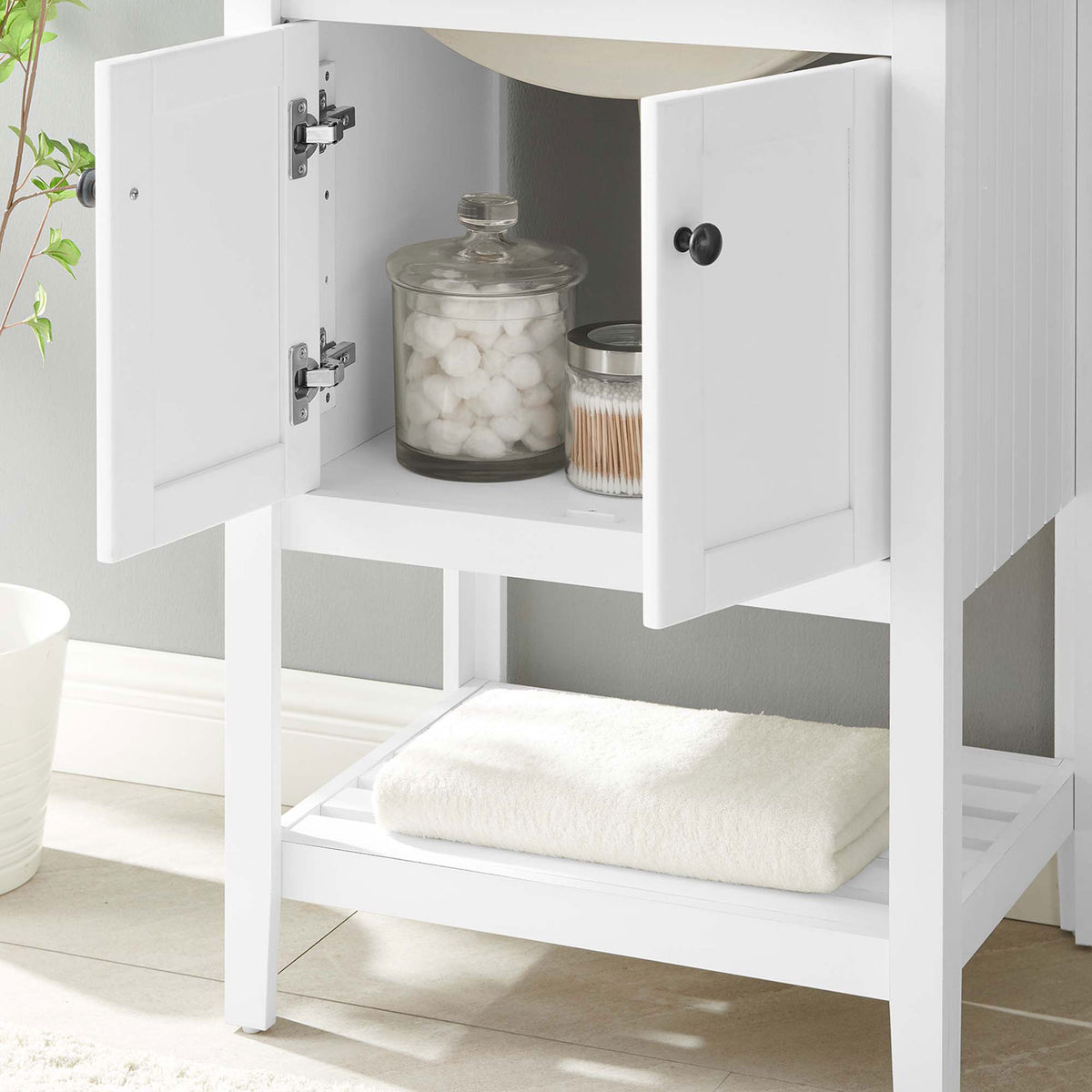 Open cabinet stores essentials while concealing plumbing; slatted lower shelf keeps towels handy || EEI-5358-WHI-BLK || storage_room