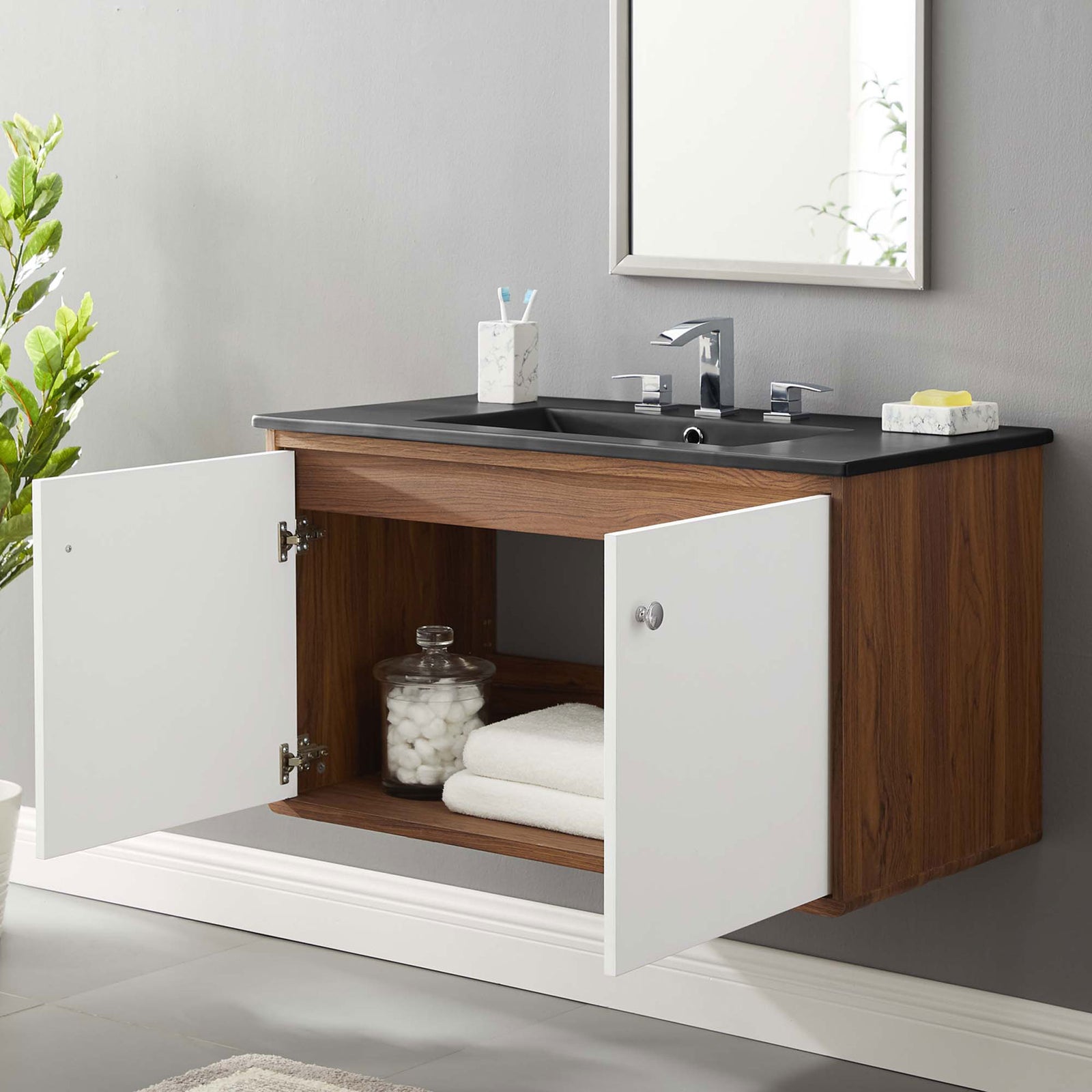 Floating vanity showcases open storage and a matte black top in a contemporary bath || EEI-5393-WAL-BLK || front_open_room