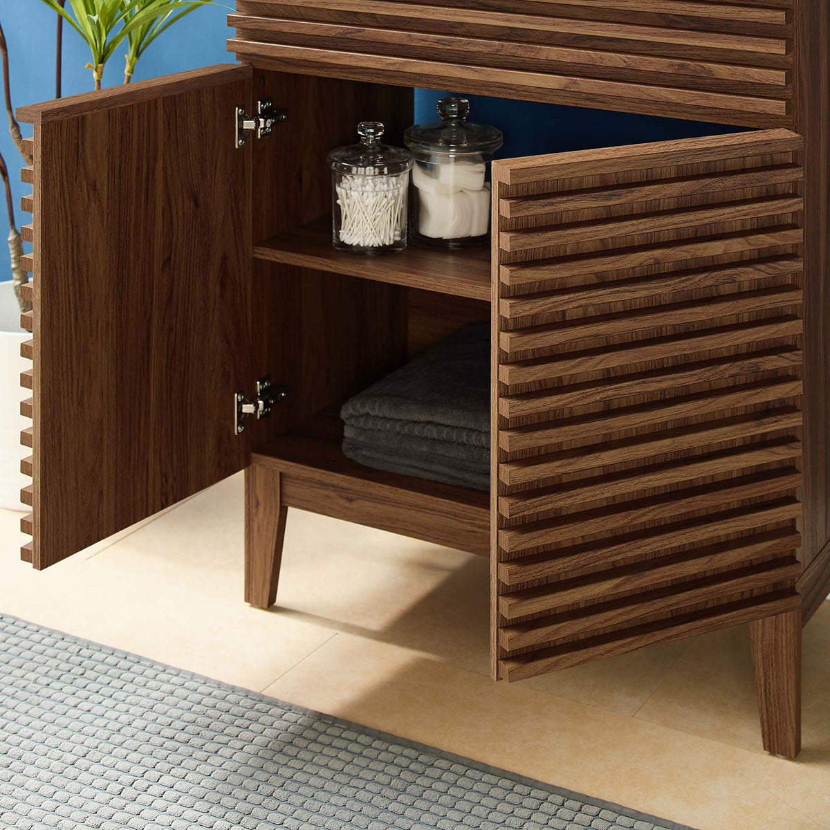 Open cabinet displays towels and jars on the adjustable shelf || EEI-5418-WAL-BLK || storage_open_room