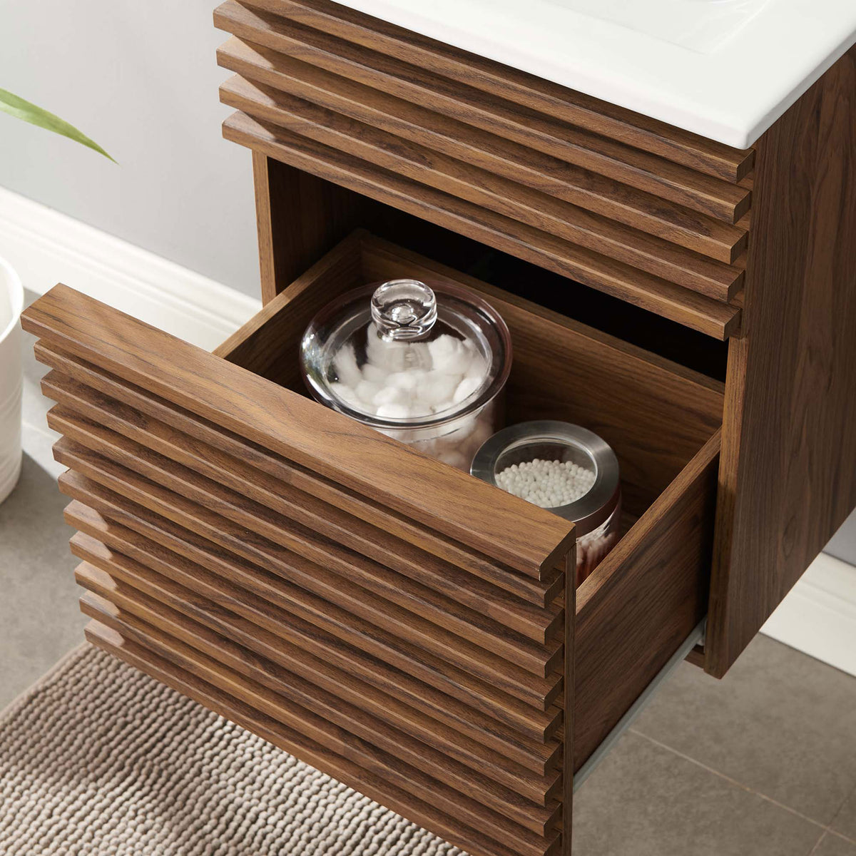 Deep, full-extension drawer offers generous bathroom storage below the sink || EEI-5419-WAL-WHI || storage_open_room