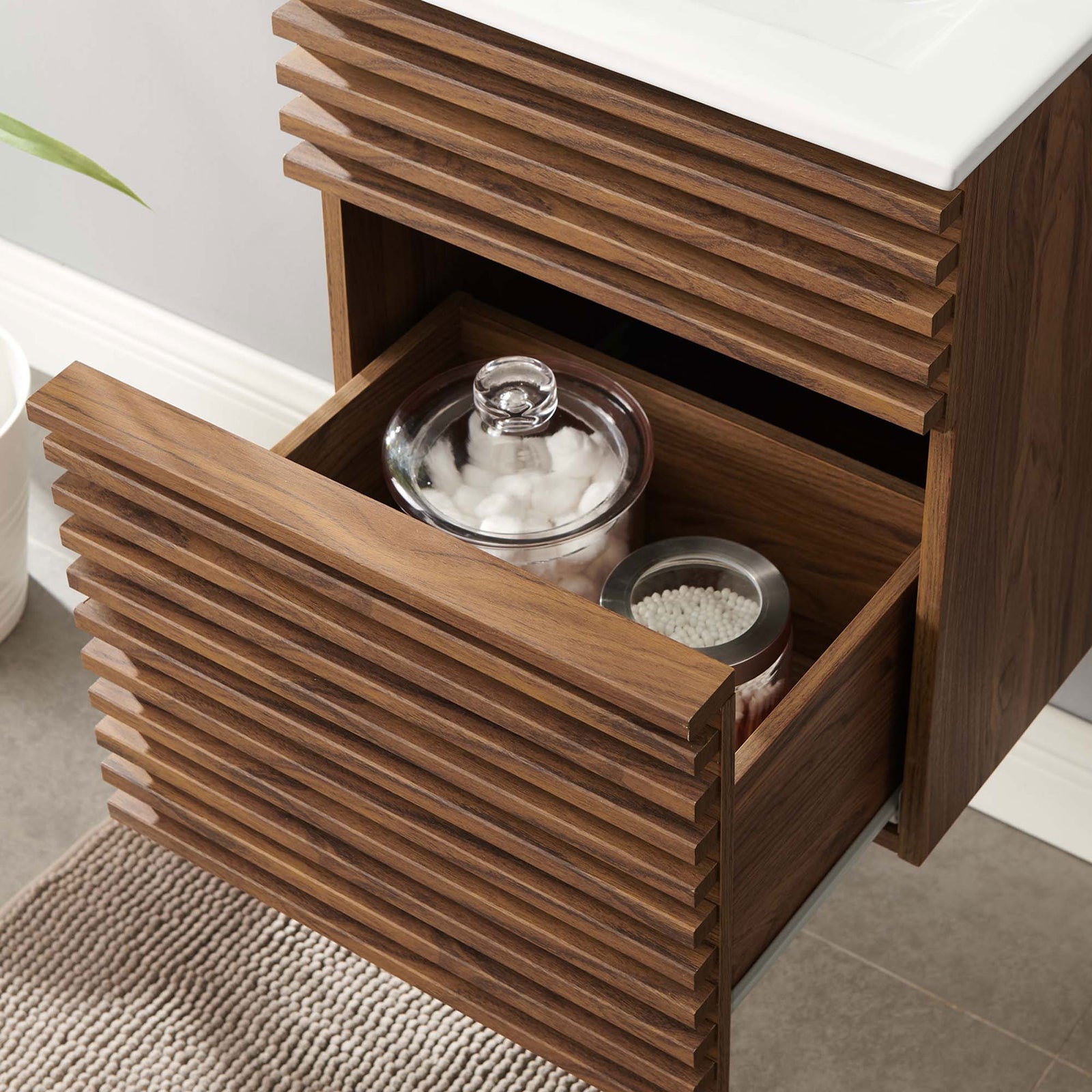 Deep, full-extension drawer offers generous bathroom storage below the sink || EEI-5419-WAL-WHI || storage_open_room