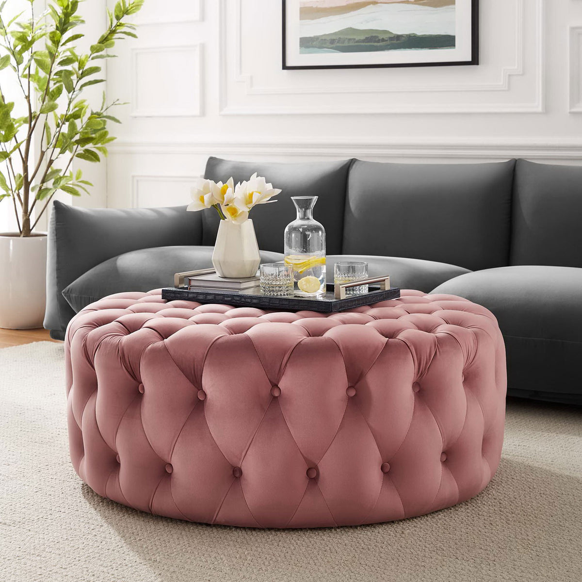 Large round dusty rose ottoman anchoring a modern living room with soft texture and glam tufting || EEI-5469-DUS || front_angle_room