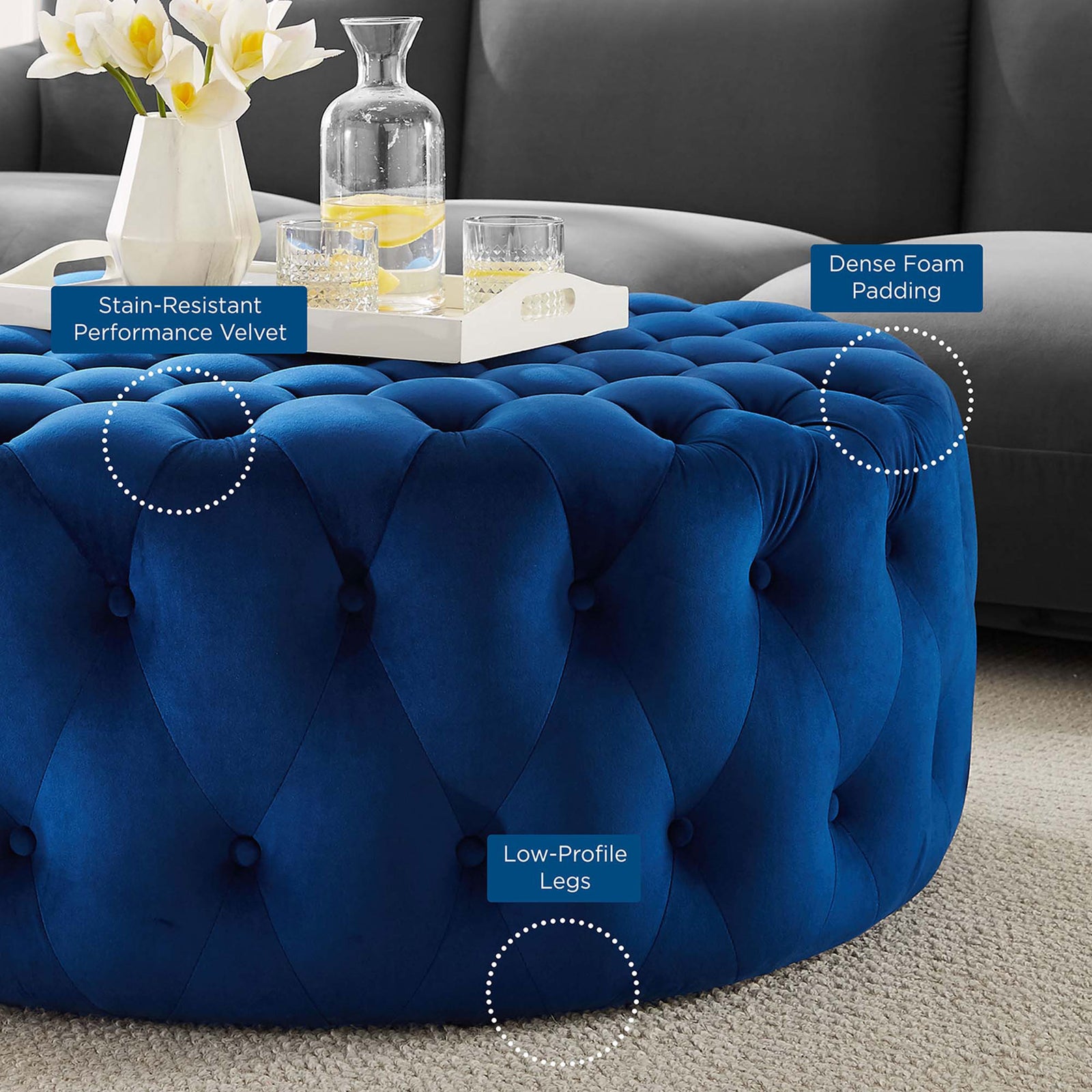 Feature callouts highlight the stain resistant velvet, dense foam padding, and low profile legs of this navy ottoman || EEI-5469-NAV || callout_room