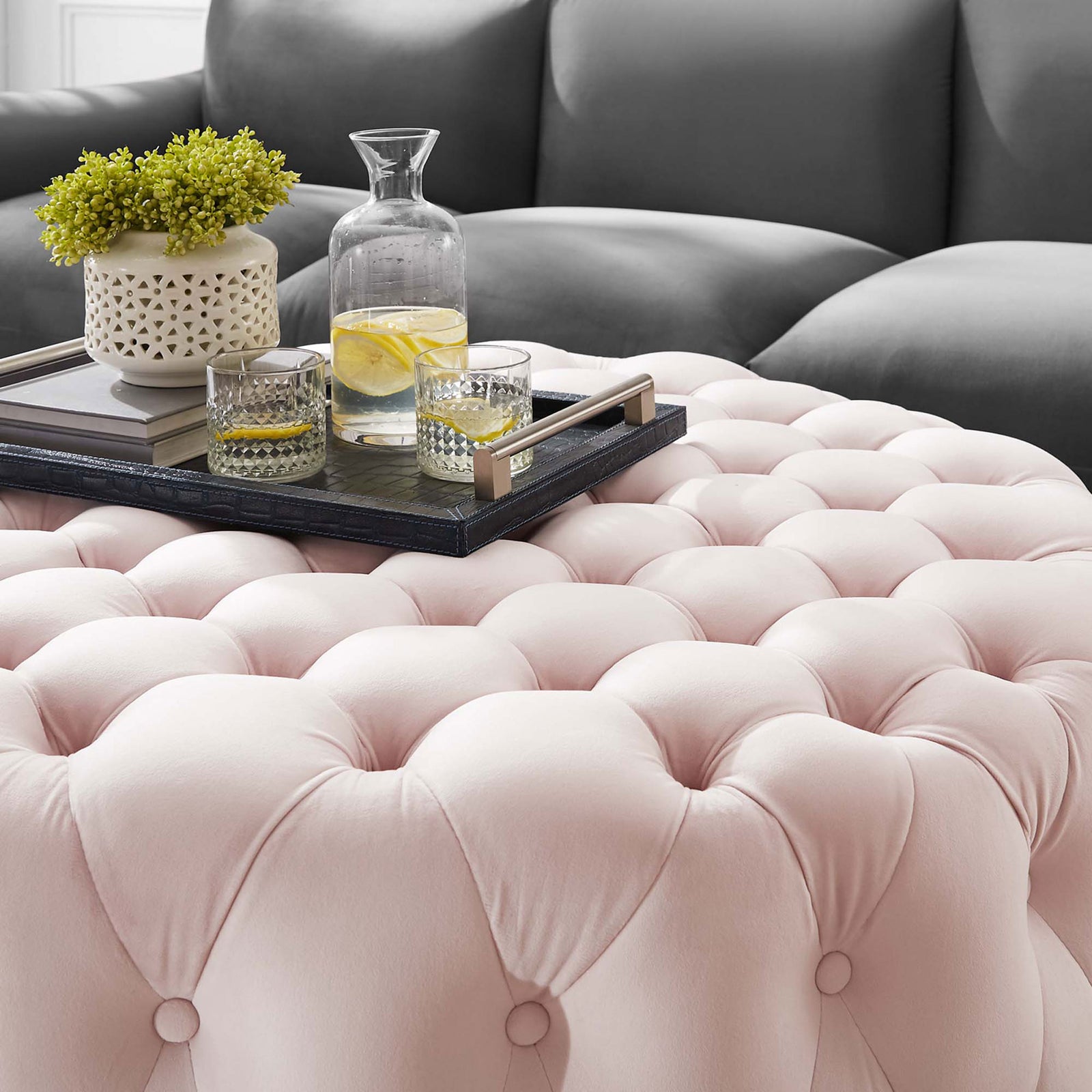 Pink velvet tufted ottoman styled as a coffee table with tray, drinks, and decor || EEI-5469-PNK || detail_room