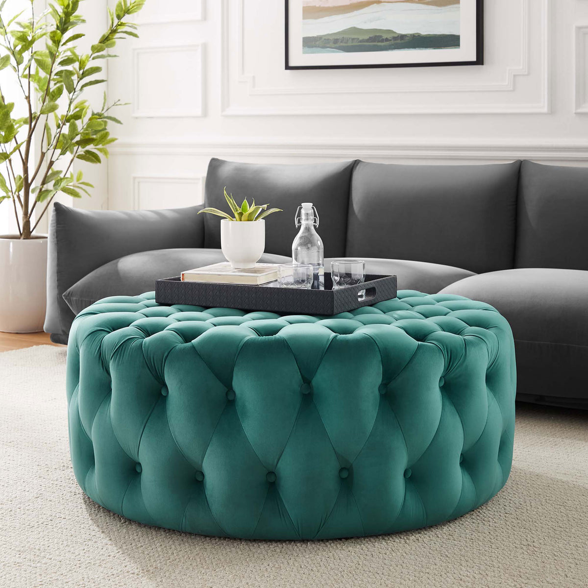 Teal velvet round ottoman anchors the living room as a plush centerpiece and versatile coffee table || EEI-5469-TEA || front_angle_room