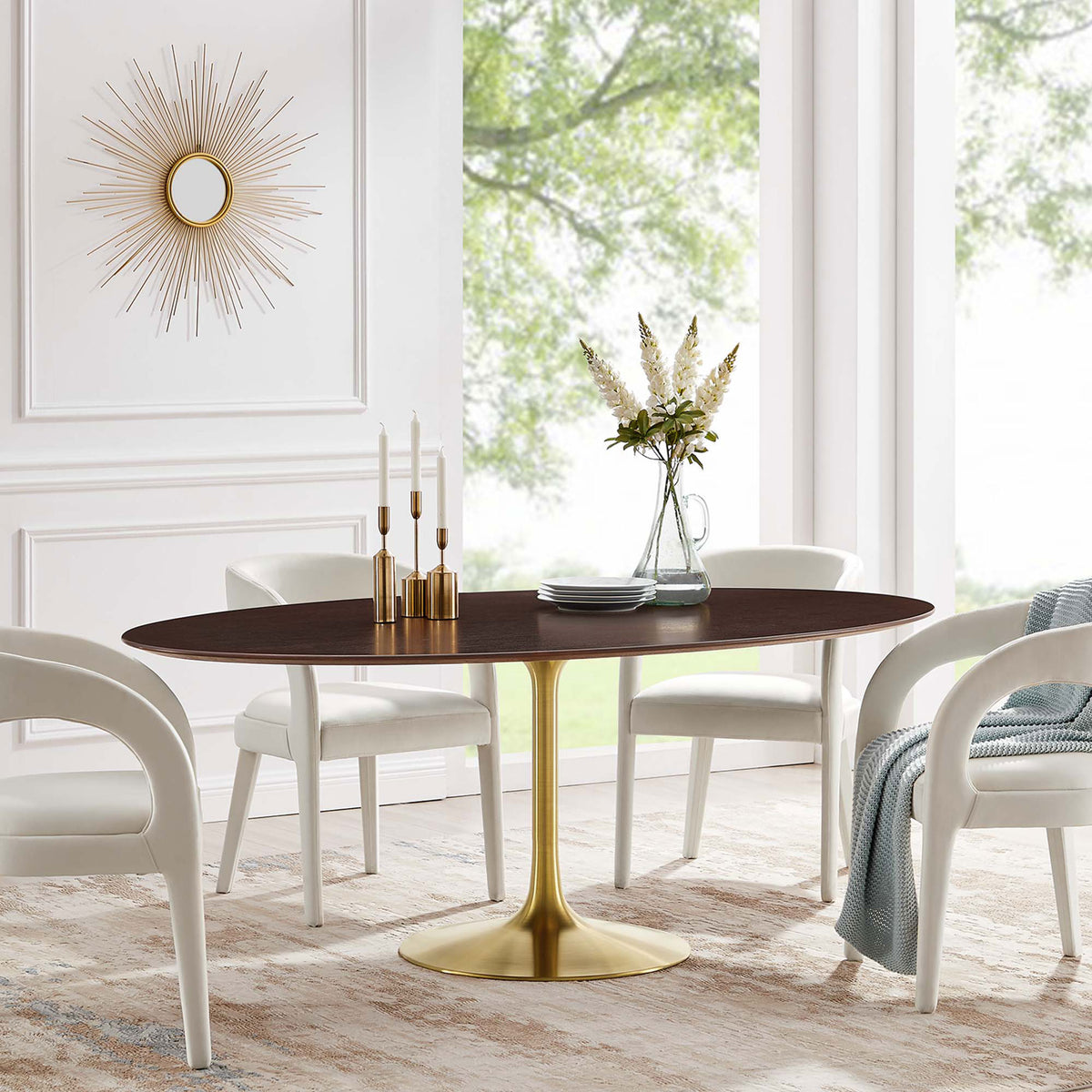 Large walnut pedestal dining table arranged with ivory chairs in a bright modern dining room || EEI-5526-GLD-CHE || front_angle_room