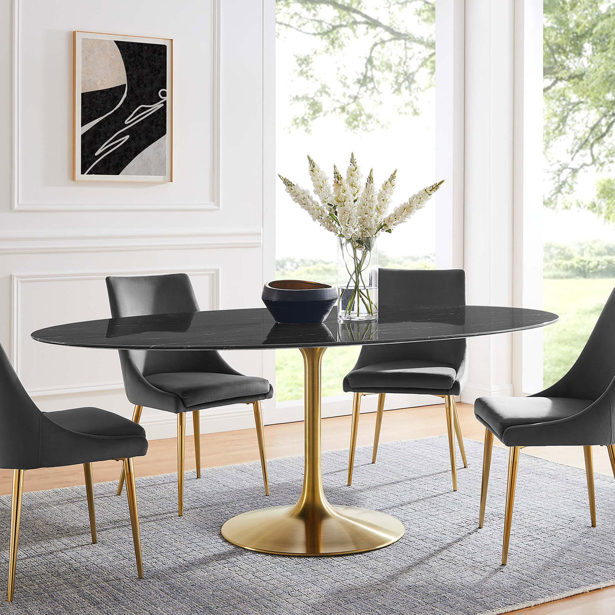 Long black oval pedestal dining table surrounded by gray chairs in an airy formal dining room. || EEI-5528-GLD-BLK || front_room