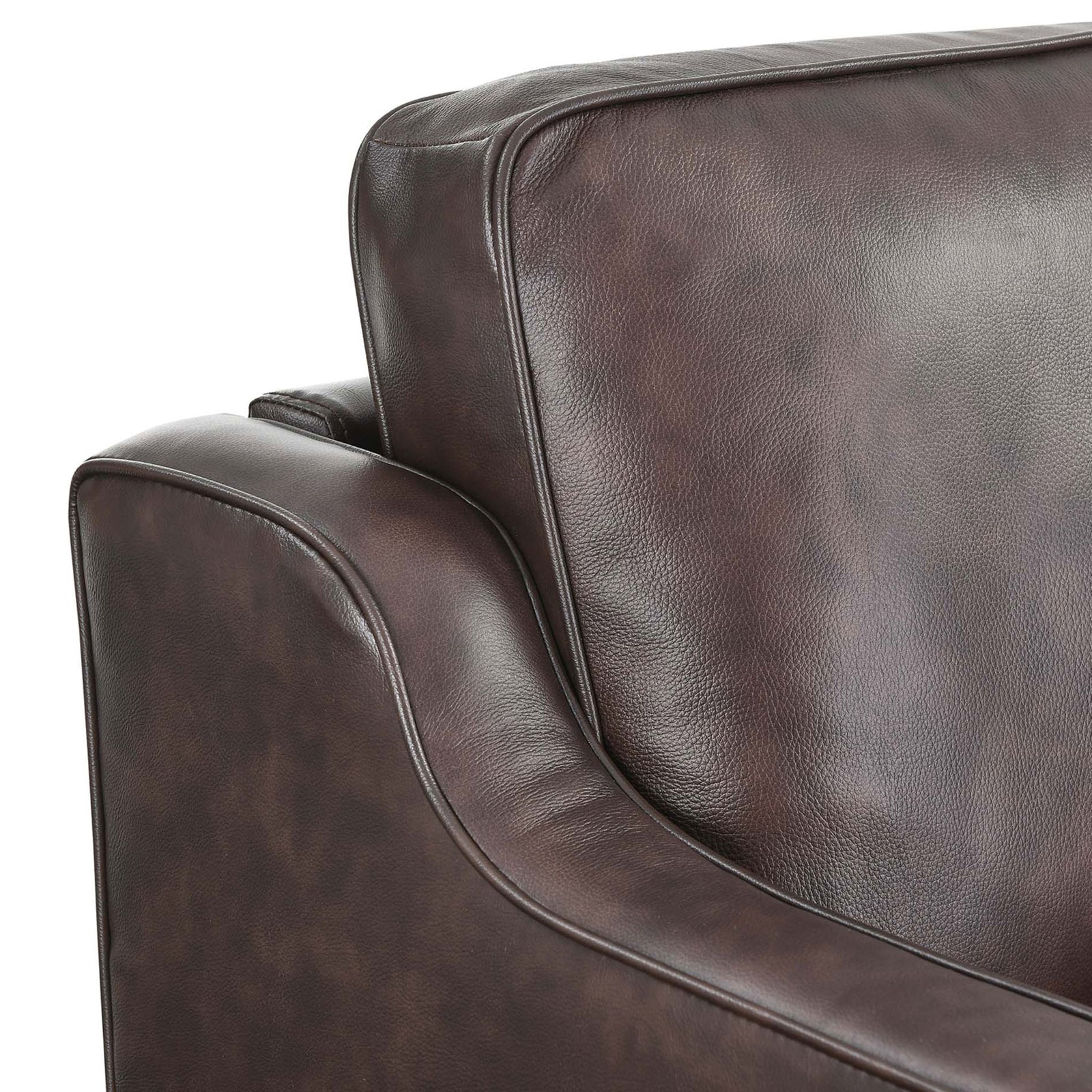 Detail of the Impart brown leather sofa showing smooth cushions and tailored piping along the arm and backrest || EEI-5553-BRN || detail_studio
