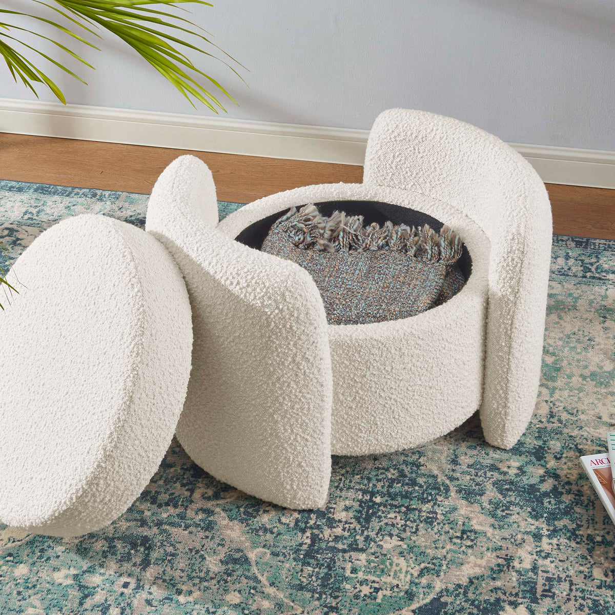 Ivory boucle storage ottoman in a living room with seat removed to hold a folded throw blanket || EEI-5561-IVO || front_angle_open_room