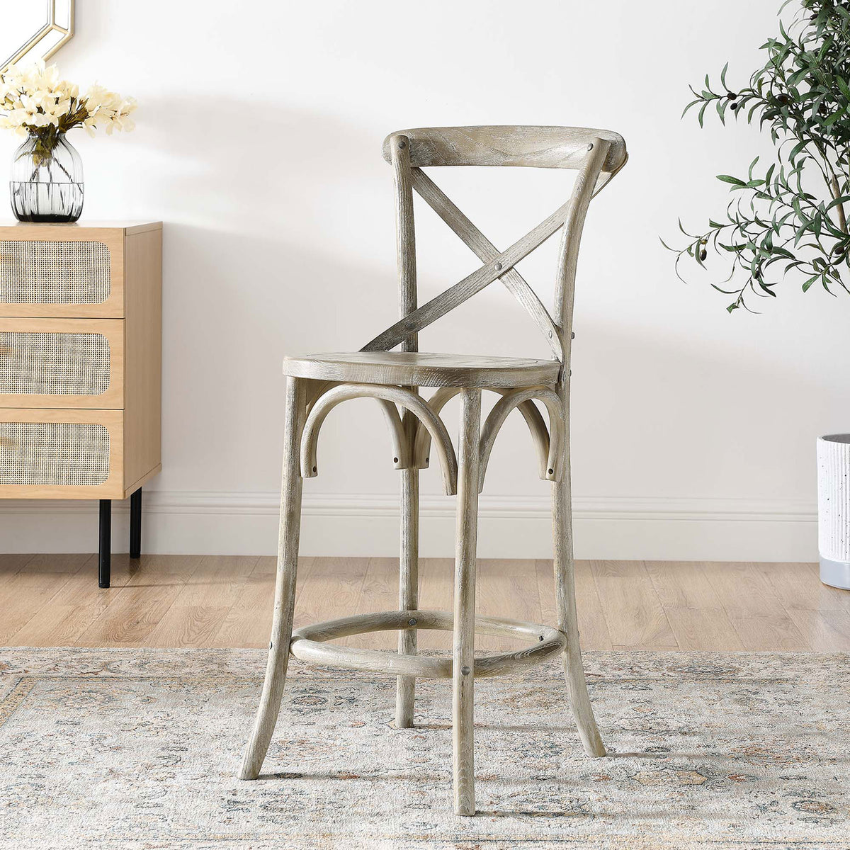 Versatile counter stool warms the room with a weathered gray finish and graceful arches. || EEI-5562-GRY || front_angle_room