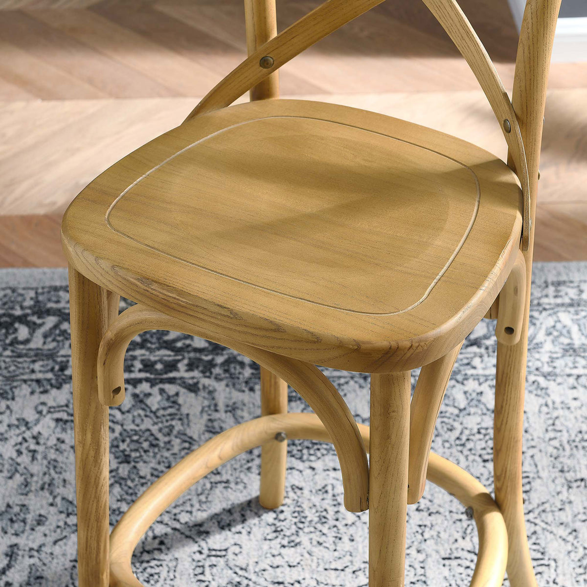 Textured wood seat detail shows rich grain and inset border over patterned rug || EEI-5562-NAT || detail_room