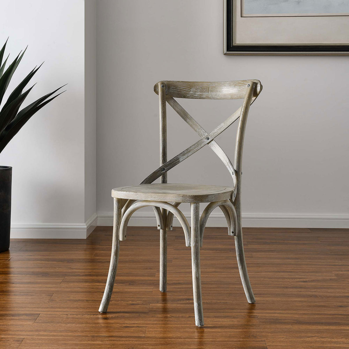 Gray farmhouse dining chair styled in a bright room with wood floors and contemporary wall art || EEI-5564-GRY || front_angle_room