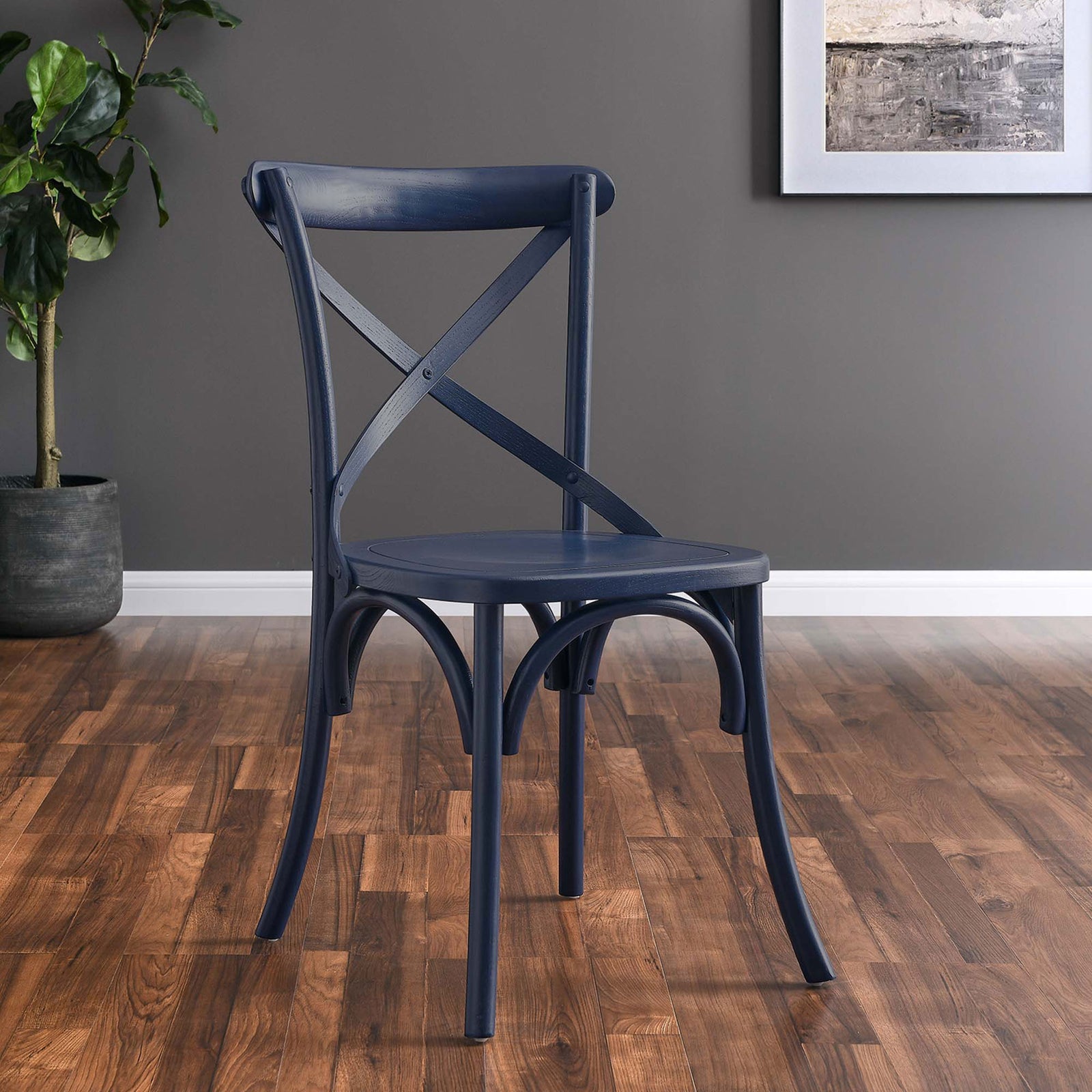 Midnight blue X-back dining chair styled in a contemporary room with warm wood flooring || EEI-5564-MID || front_angle_room