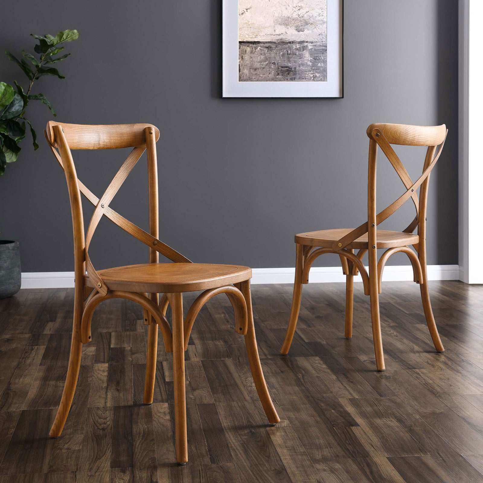 Two walnut dining chairs in a modern room, showcasing curved legs and a warm wood finish || EEI-5564-WAL || back_angle_room
