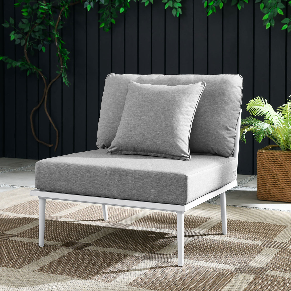 Gray Stance armless chair with white frame styled on a patio with plants and woven rug || EEI-5568-WHI-GRY || front_angle_room