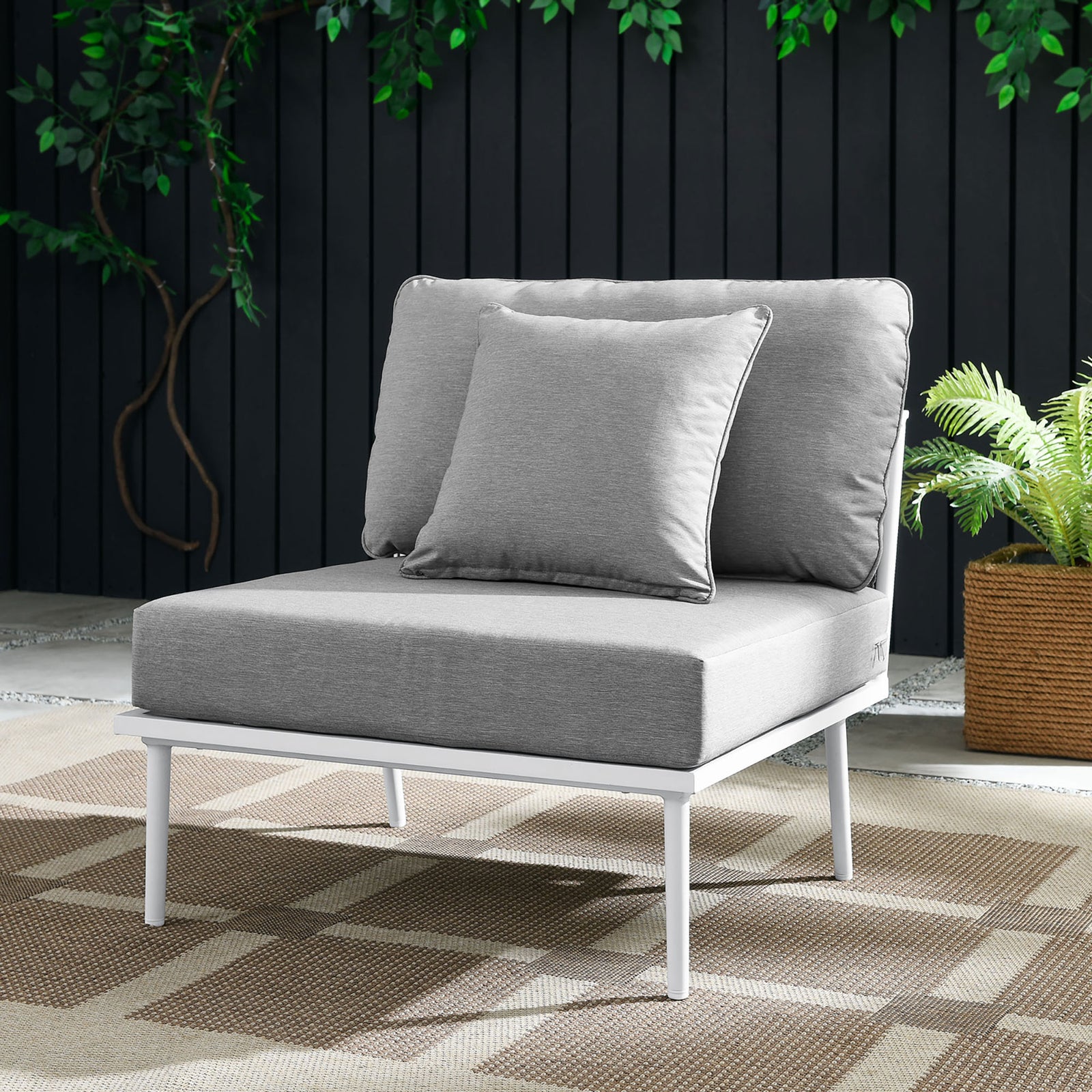Gray Stance armless chair with white frame styled on a patio with plants and woven rug || EEI-5568-WHI-GRY || front_angle_room