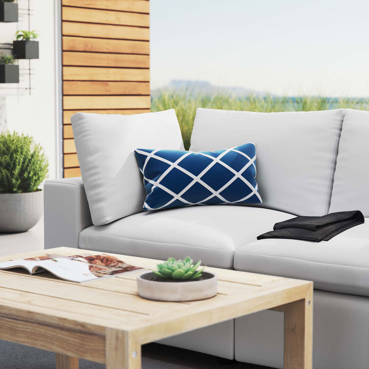 White patio loveseat styled with a wood coffee table and blue accent pillow on a modern terrace || EEI-5577-WHI || detail_room