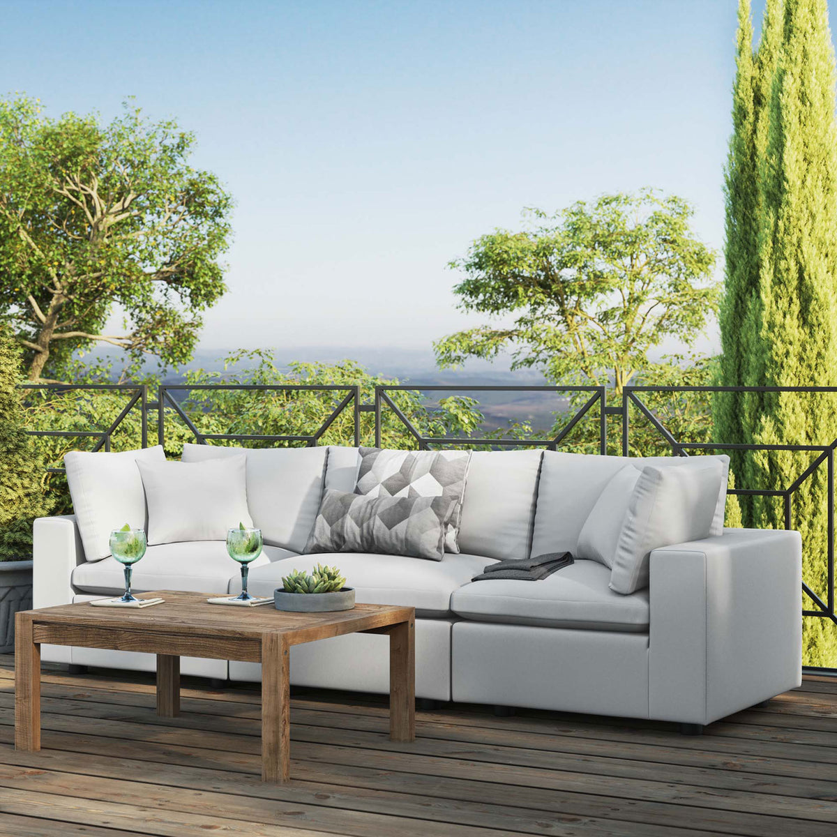 White three-seat outdoor sofa on a scenic rooftop deck paired with a simple wood coffee table || EEI-5578-WHI || front_angle_room