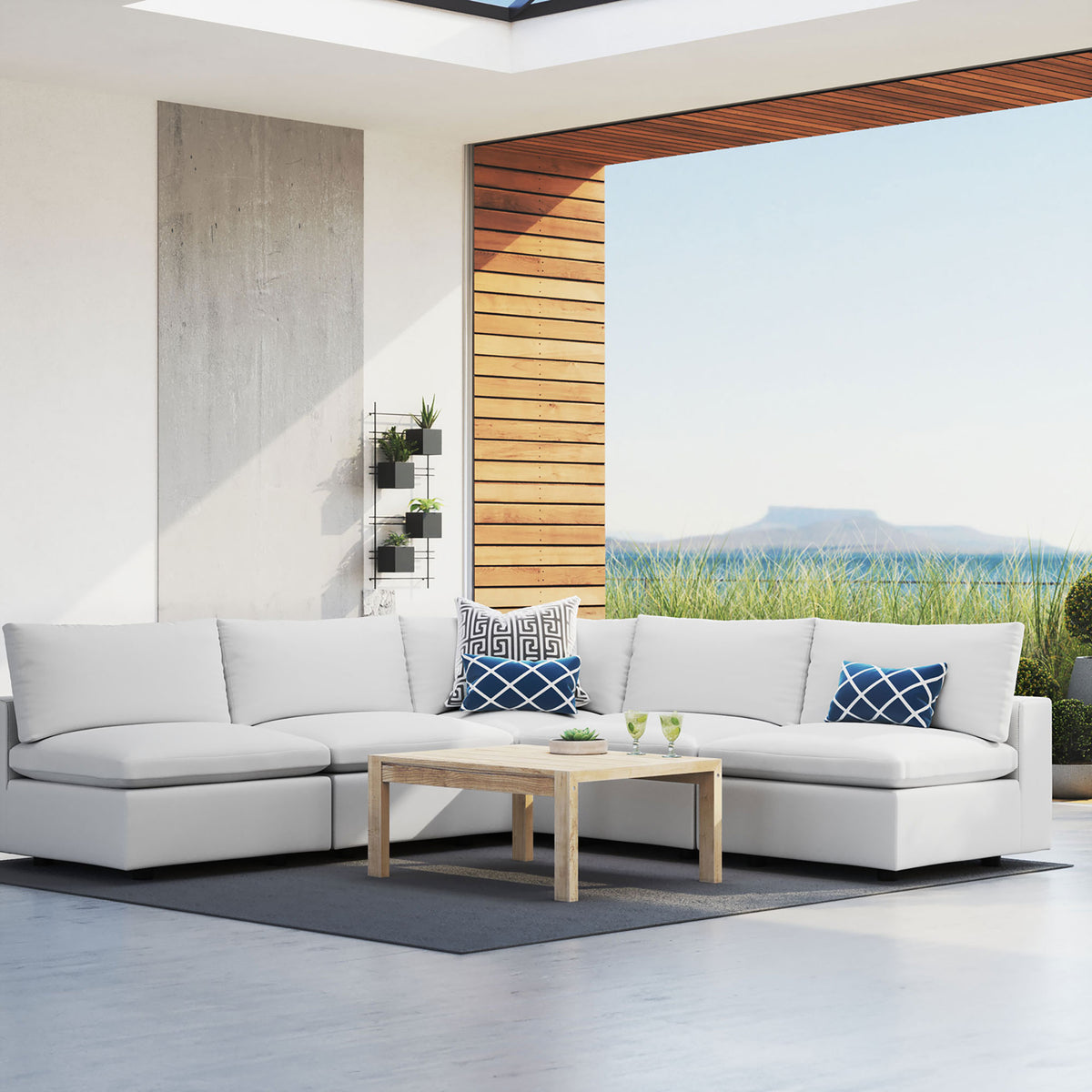 White Commix Sunbrella sectional forming an inviting outdoor lounge with expansive water views. || EEI-5588-WHI || front_angle_room