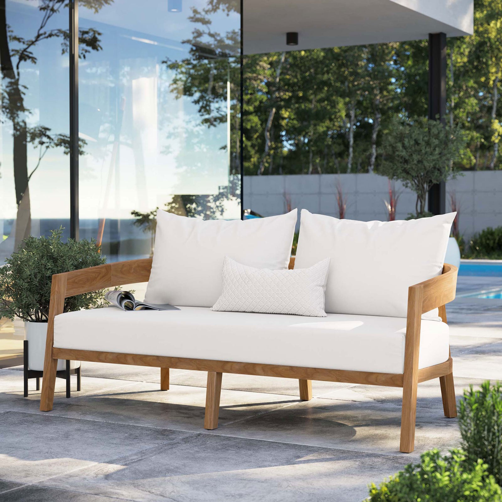 White cushioned teak loveseat creates a bright, inviting focal point on a poolside terrace || EEI-5601-NAT-WHI || front_angle_room