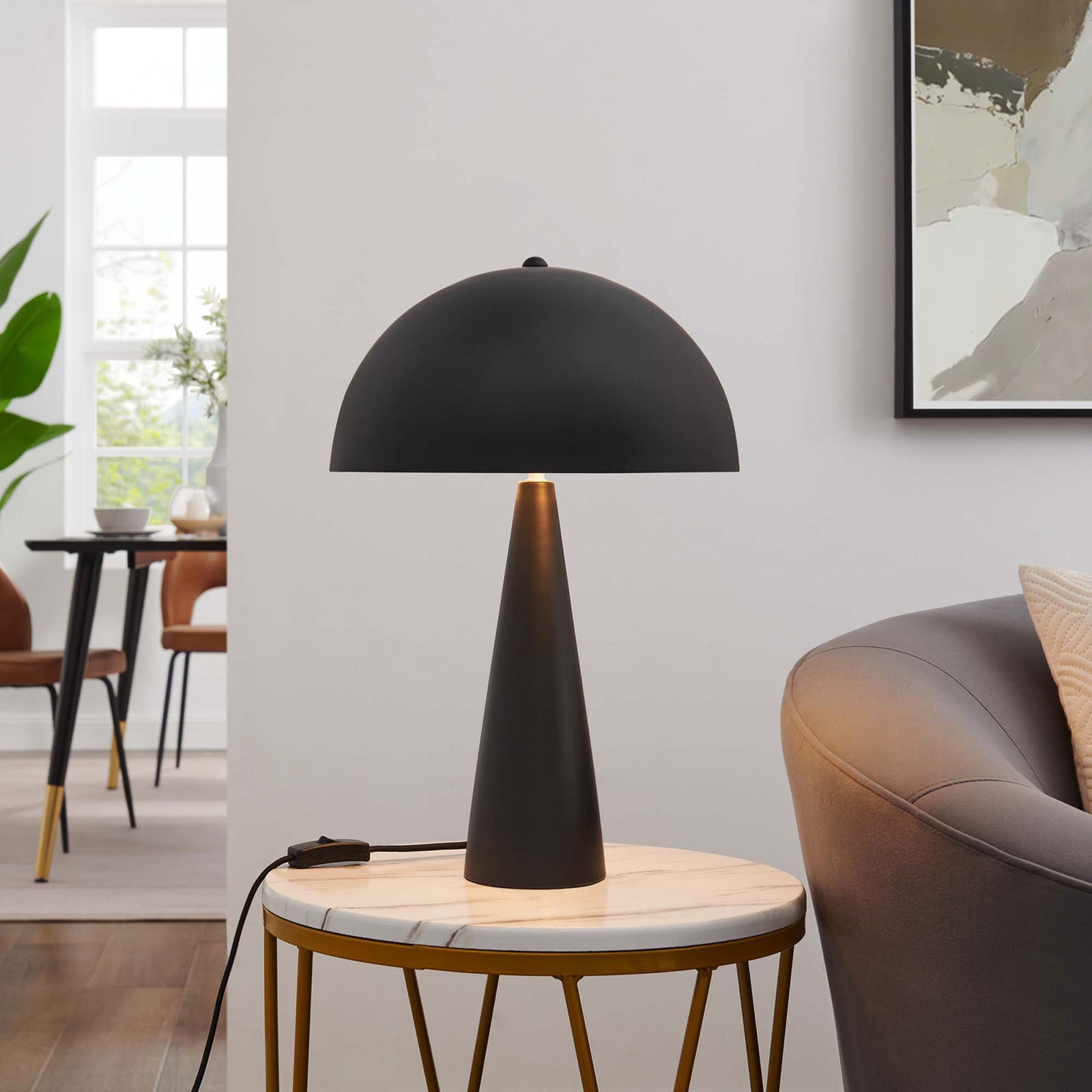 Selena table lamp glowing warmly on a marble side table, creating cozy ambient light in the living room || EEI-5624-BLK || front_on_room
