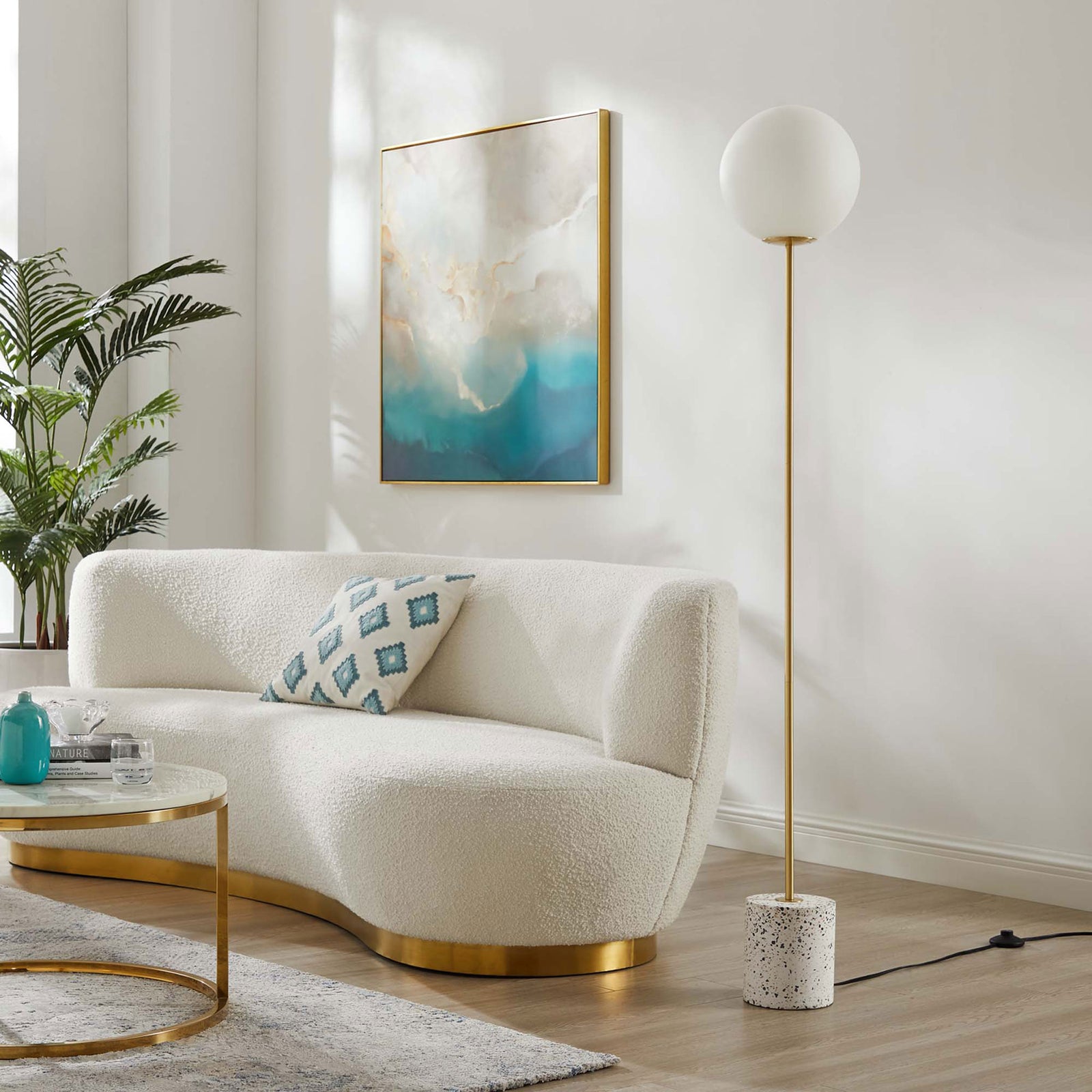 Logic floor lamp beside a curved sofa, adding sculptural modern style to a bright living room || EEI-5626-WHI || front_room