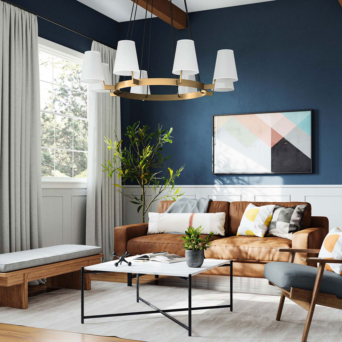 Modern ring chandelier anchors the seating area with warm brass tones and tailored white shades || EEI-5641-WHI-SBR || front_angle_room