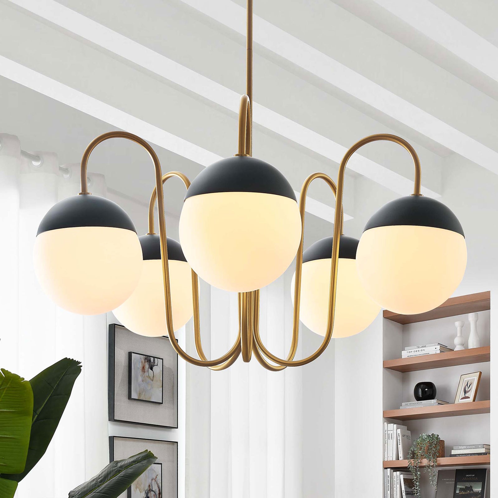 Satin brass chandelier casts a warm glow through five opal globes, elevating contemporary decor || EEI-5658-OPA-SBR || front_on_room