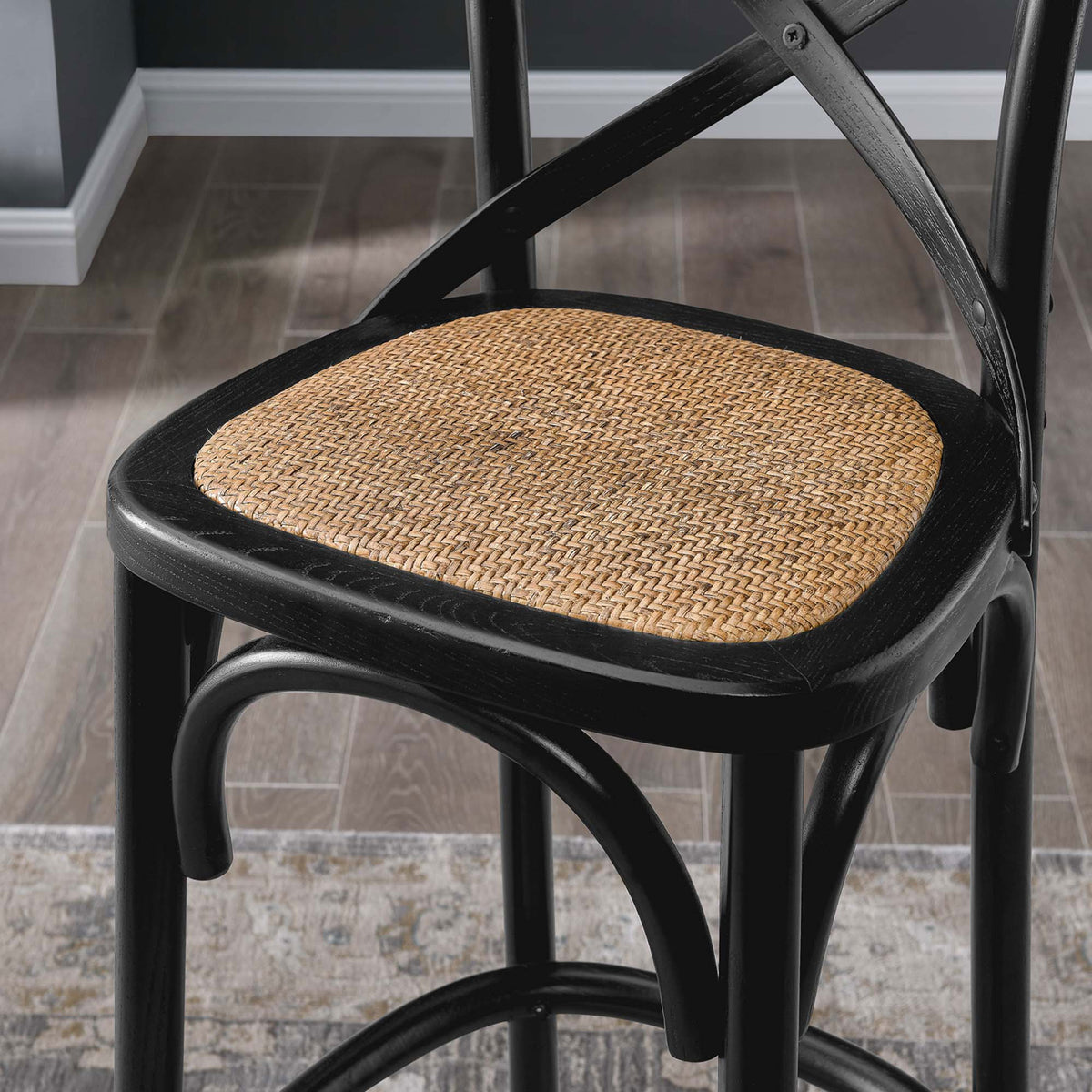 Natural rattan seat texture pairs with the black wood frame for warm contrast. || EEI-5668-BLK || detail_room