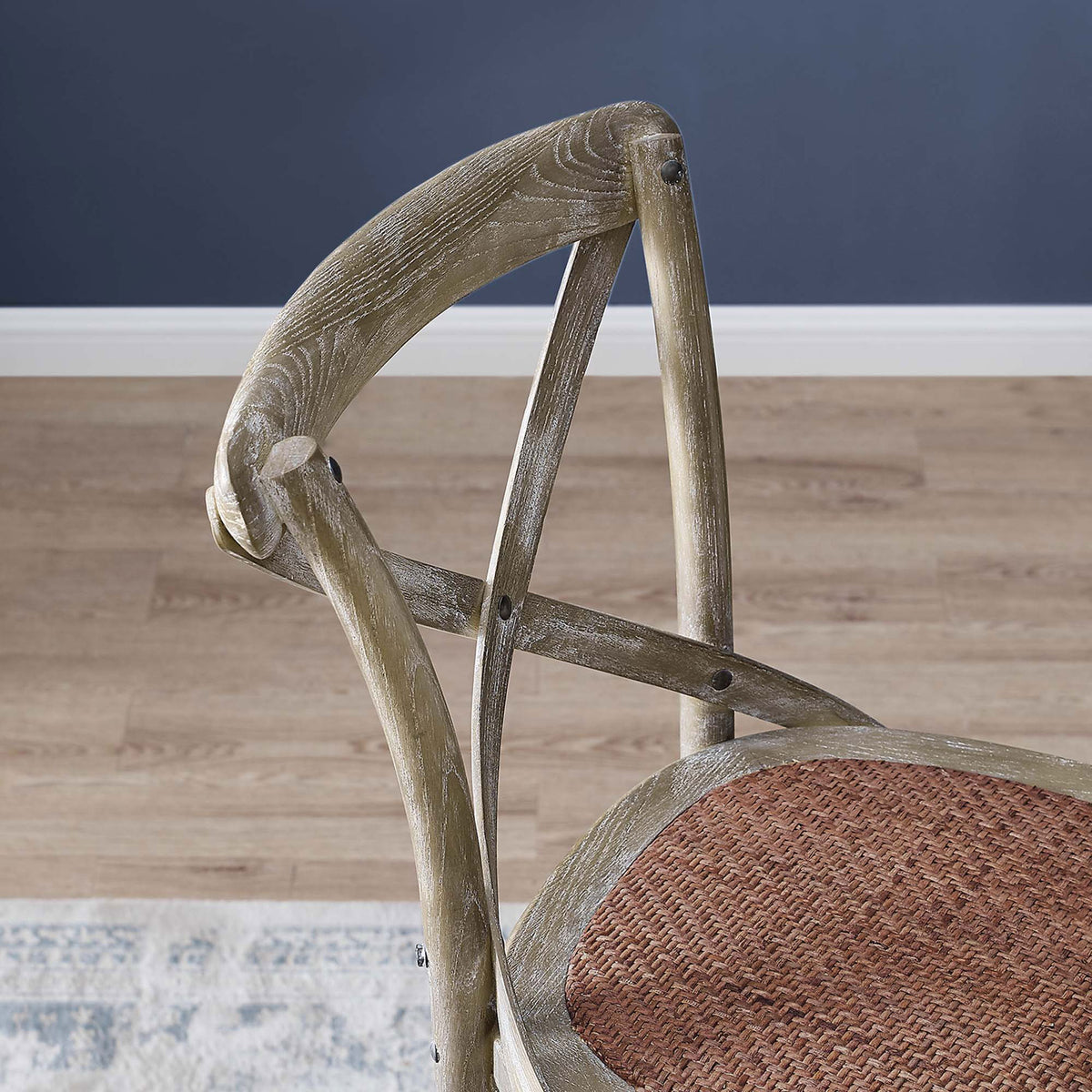 Close look at the sculpted cross-back and grain detail in the weathered gray elm frame || EEI-5668-GRY || detail_room