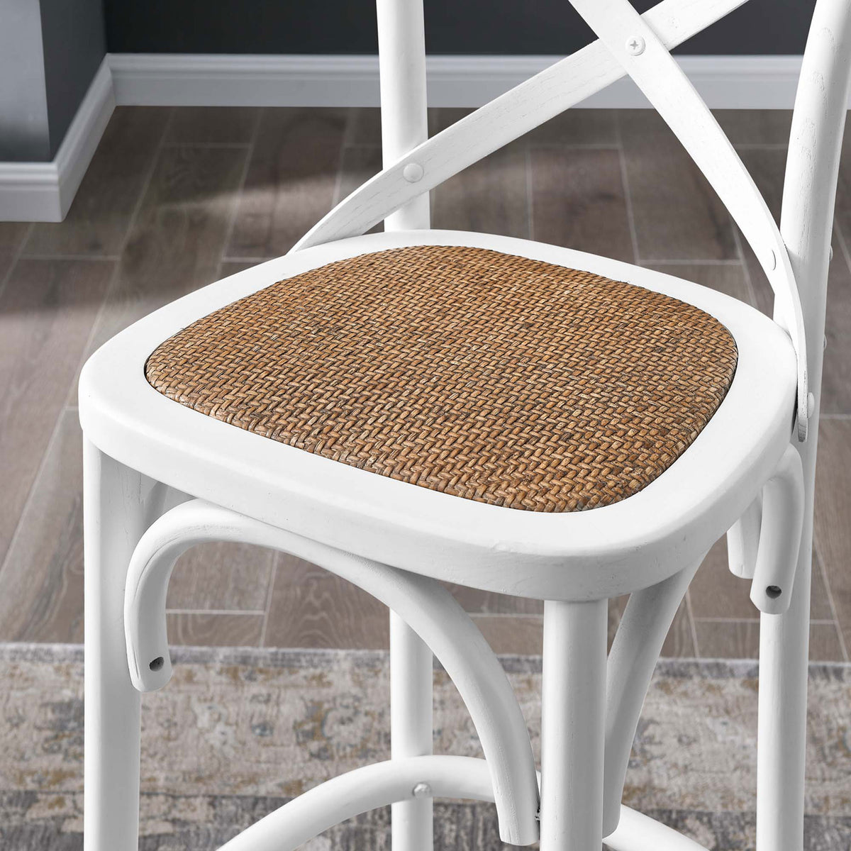 Textural rattan seat adds warmth against the crisp white frame. || EEI-5668-WHI || detail_room