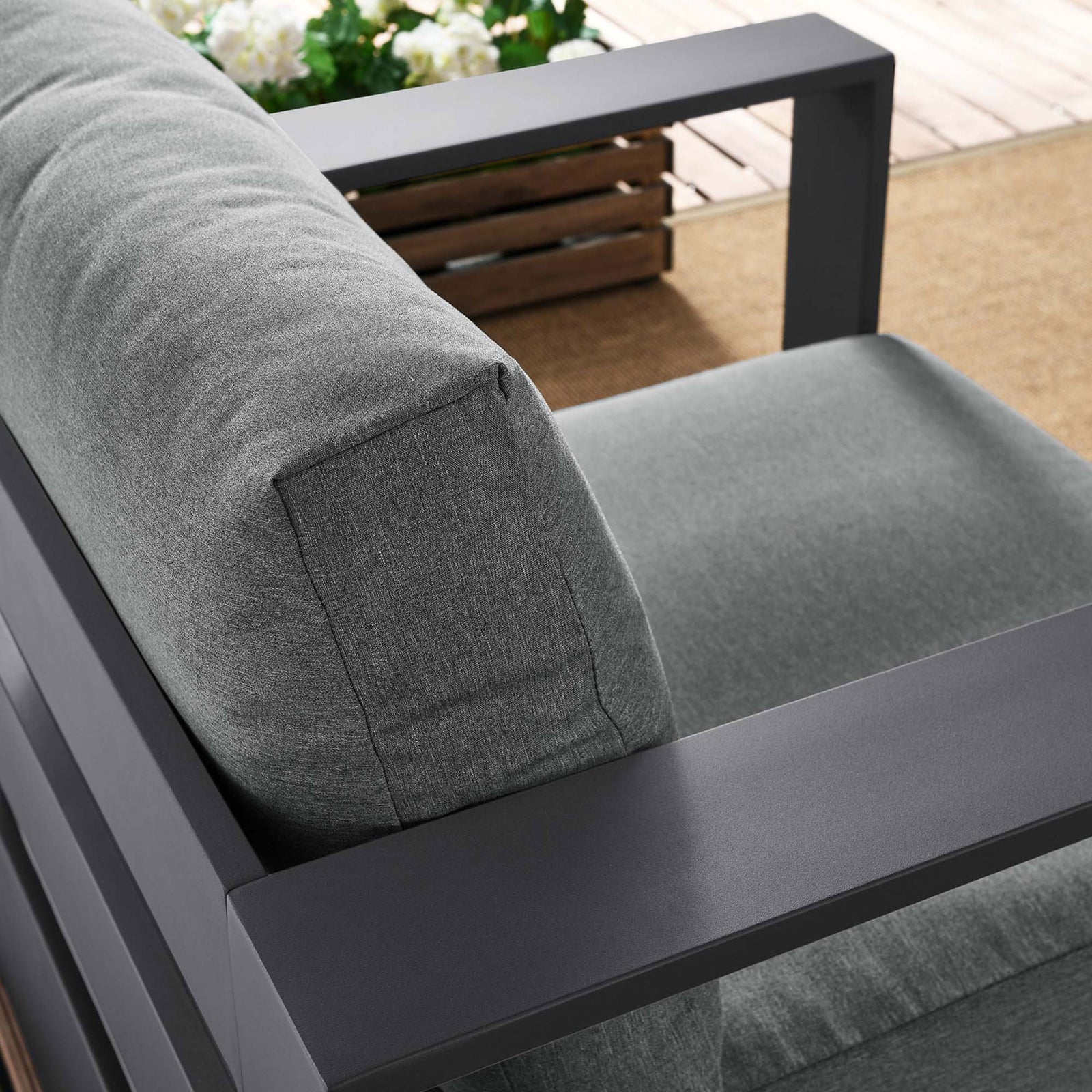 Tahoe armchair back cushion and armrest styled outdoors with textured gray upholstery and charcoal frame || EEI-5675-GRY-CHA || detail_room