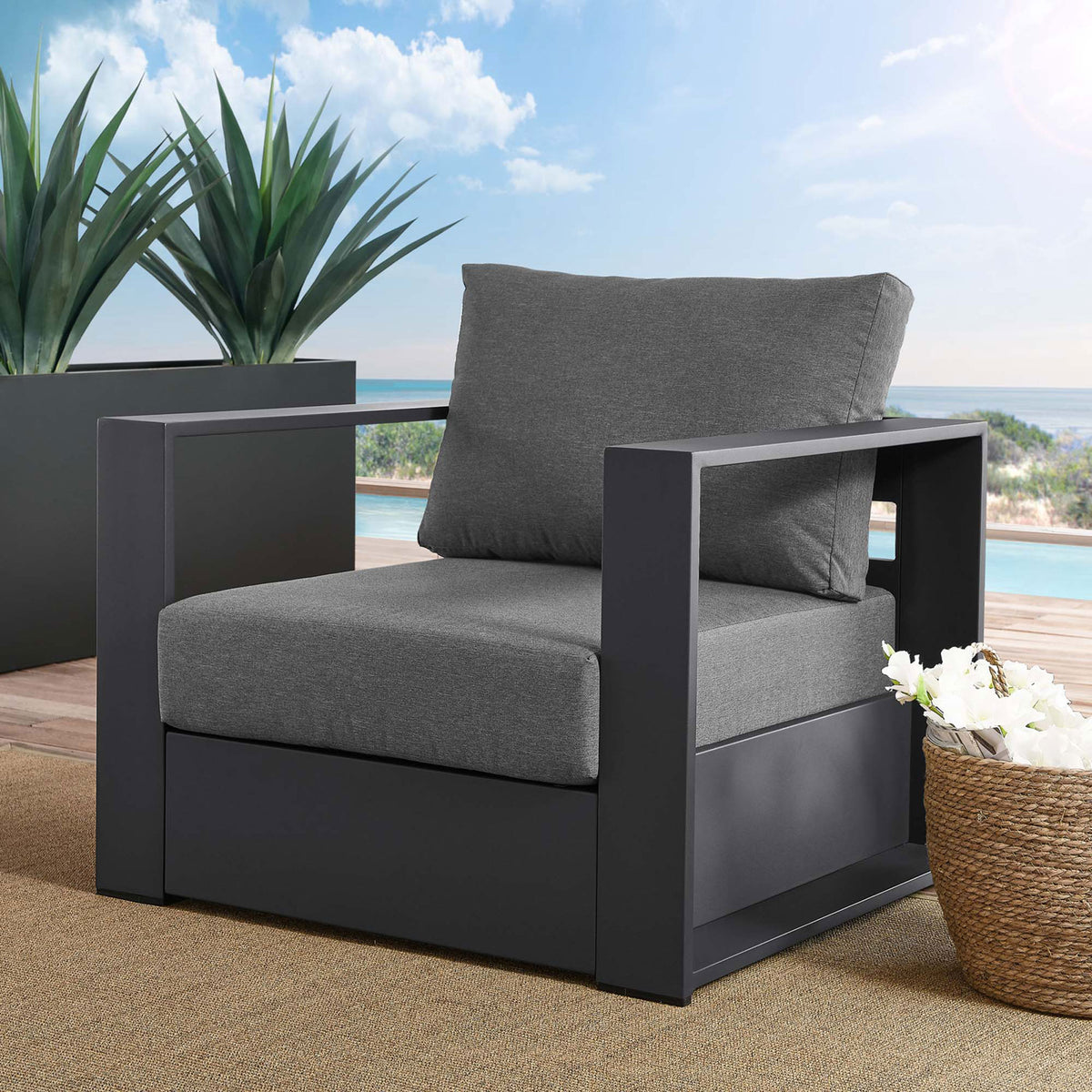 Tahoe aluminum outdoor armchair with gray cushions arranged on a sunny poolside deck || EEI-5675-GRY-CHA || front_angle_room